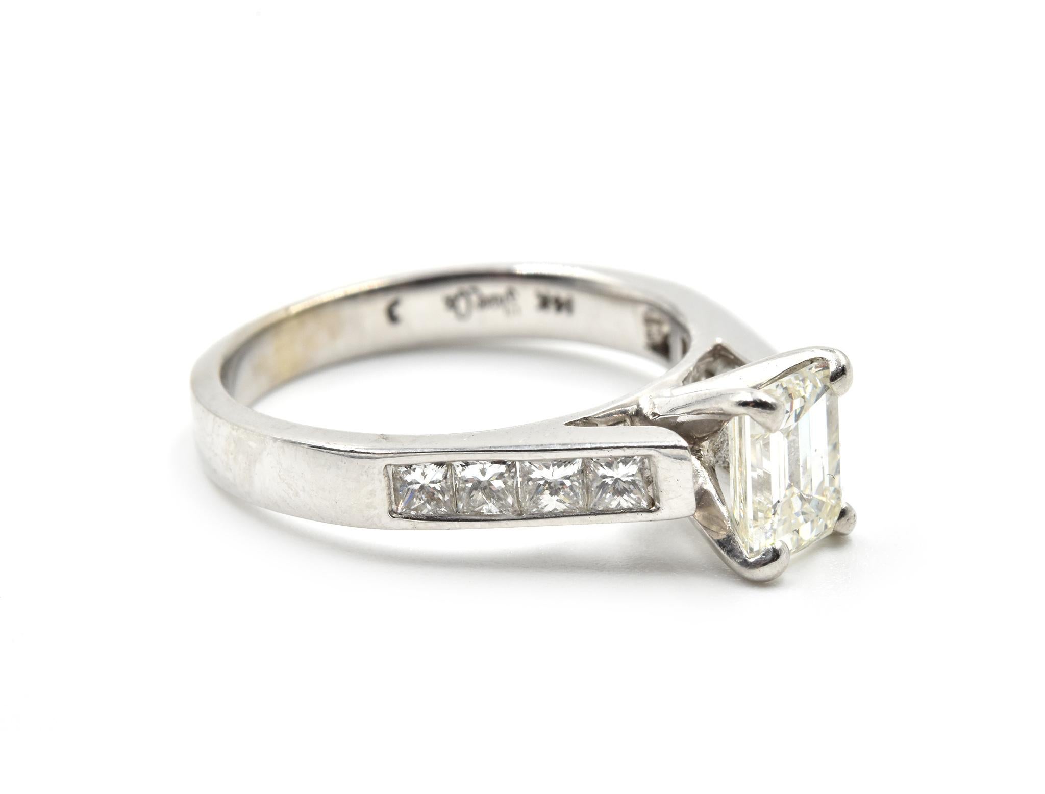 The center stone of this wedding set is a 0.95ct emerald cut diamond, the engagement ring and wedding band have princess cut diamonds set in the band. The center stone is graded I in color and VS1 in clarity. The engagement ring has elevated