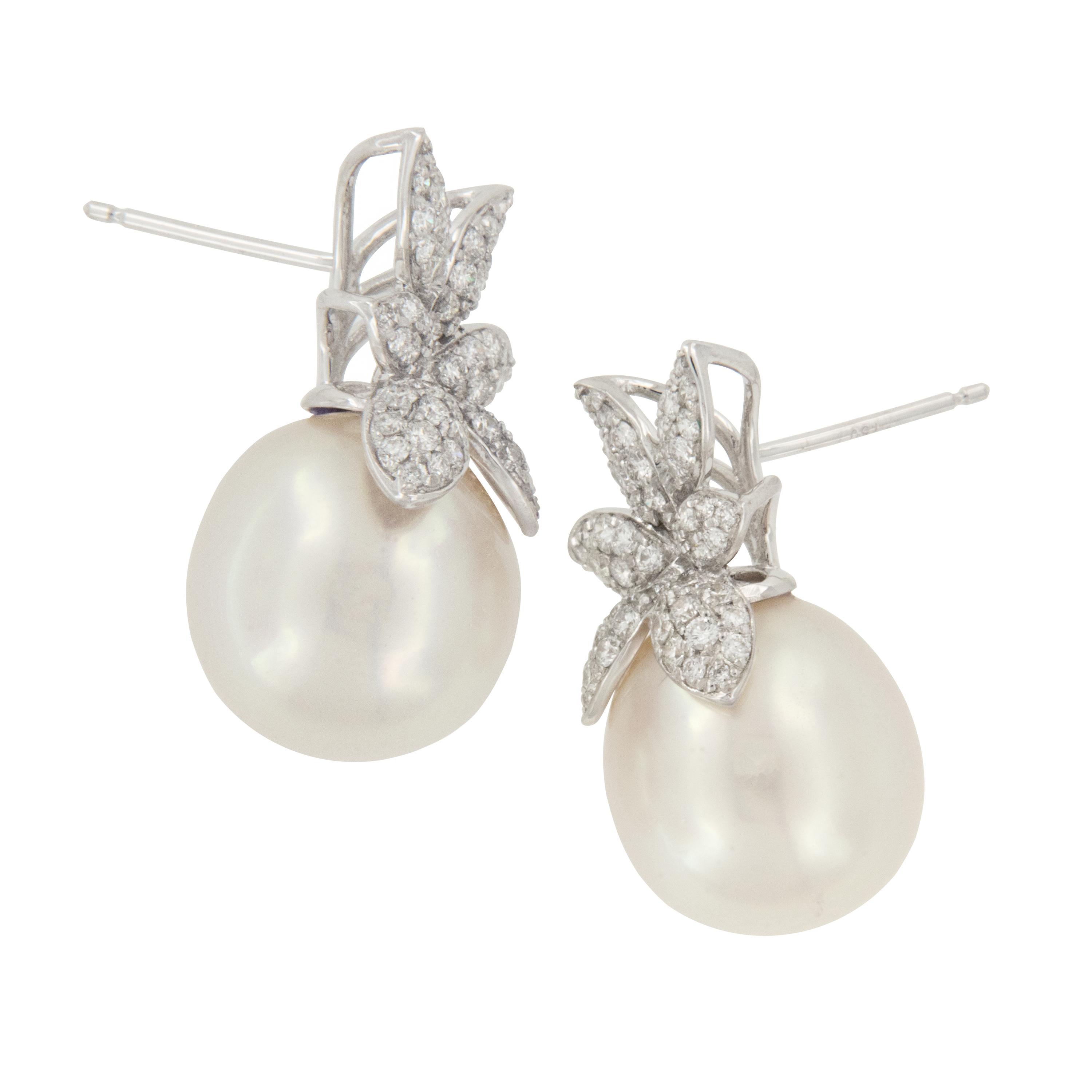 These elegant floral designed earrings with lustrous white South Sea pearls make any occasion special! Crafted in royal 18 karat white gold, these earrings are pave' set with 124 diamonds = 1.03 Cttw.  and are show stoppers on your ears!