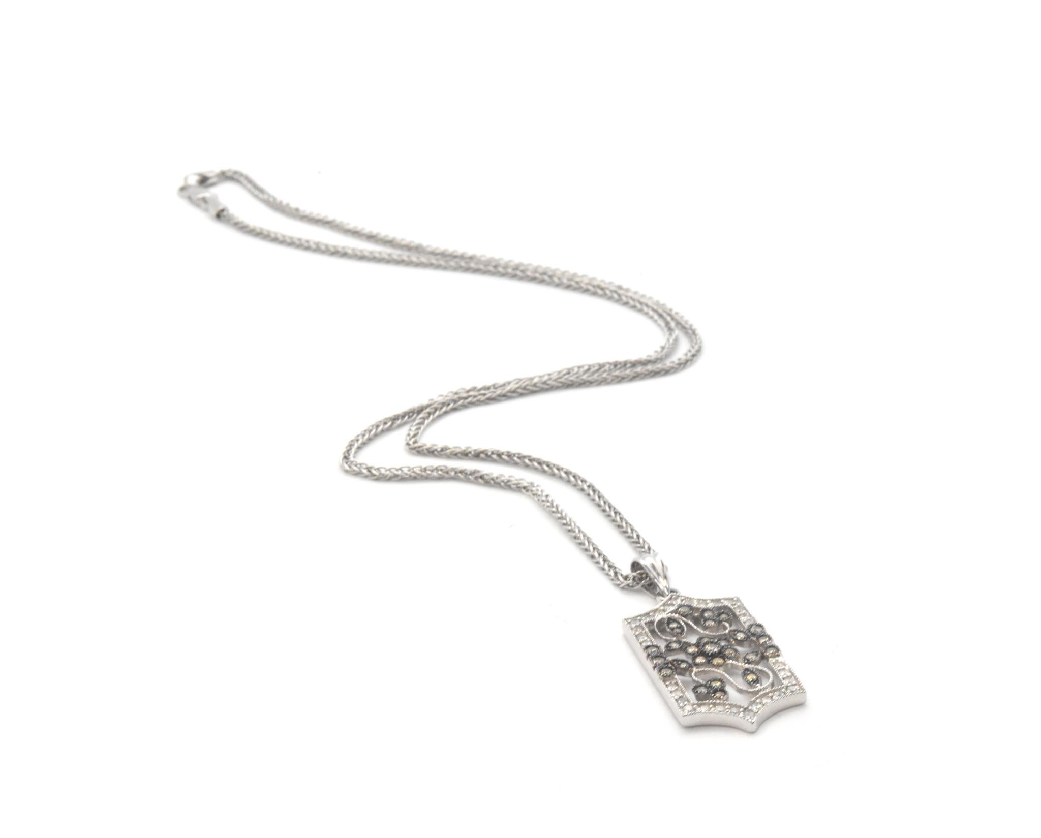 This gorgeous 14k necklace features a pendant with white and cognac diamonds set into 14k white gold. The diamonds have a total weight of 1.10 carats, and the white diamonds are graded H in color and I in clarity. The pendant measures 38x16mm. The