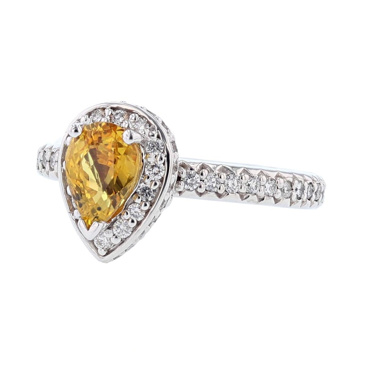 This ring is set in 14 karat white gold. The center stone is a Pear shaped Yellow Sapphire weighing 1.40 carats and is prong set. The mounting features 78 round cut, prong set diamonds weighing 0.68cts.