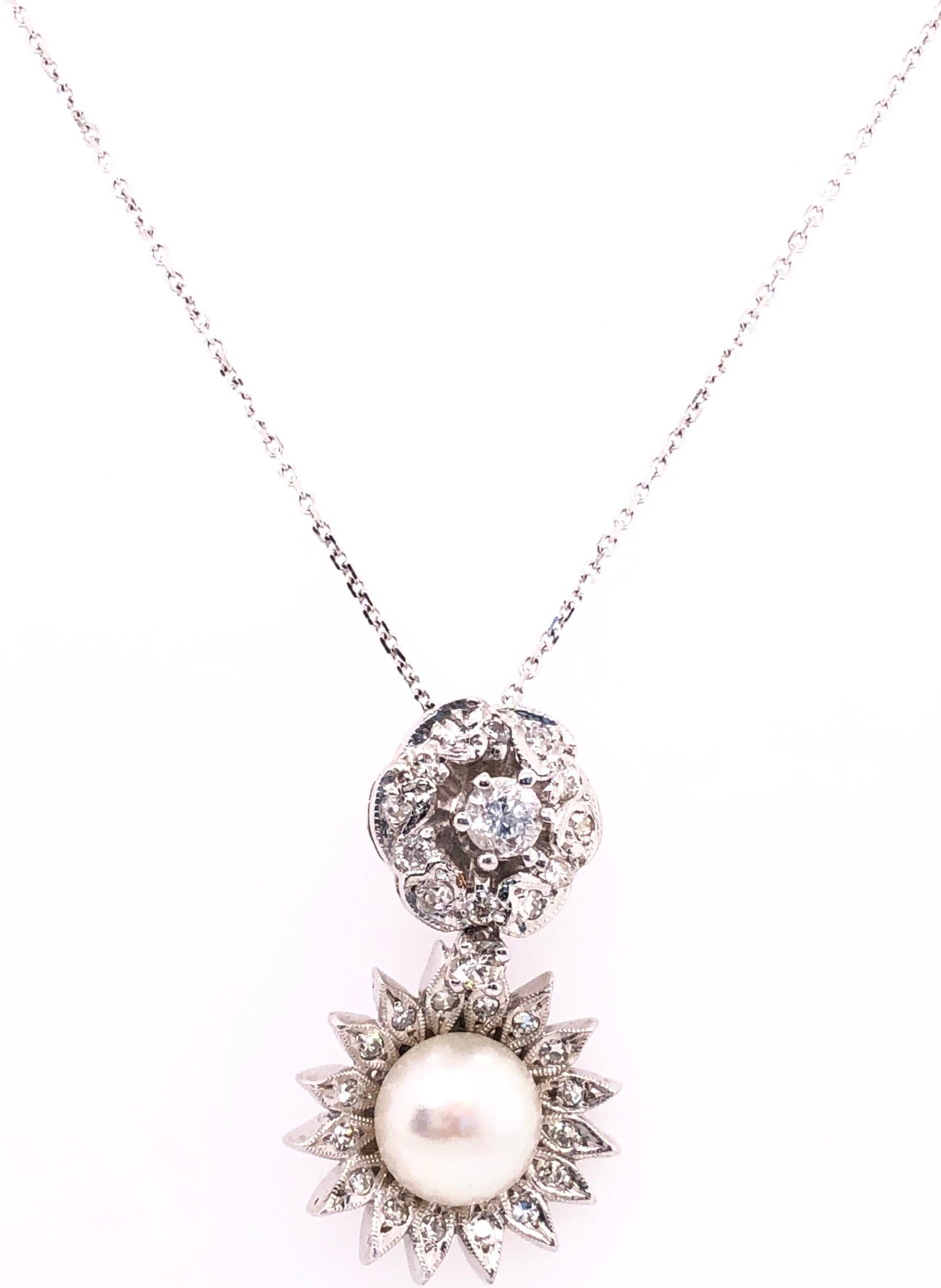 14 Karat White Gold 16 Inch Necklace with Diamond and Cultured Pearl Pendant.
0.85 Total Diamond Weight.
6.10 gram total weight.