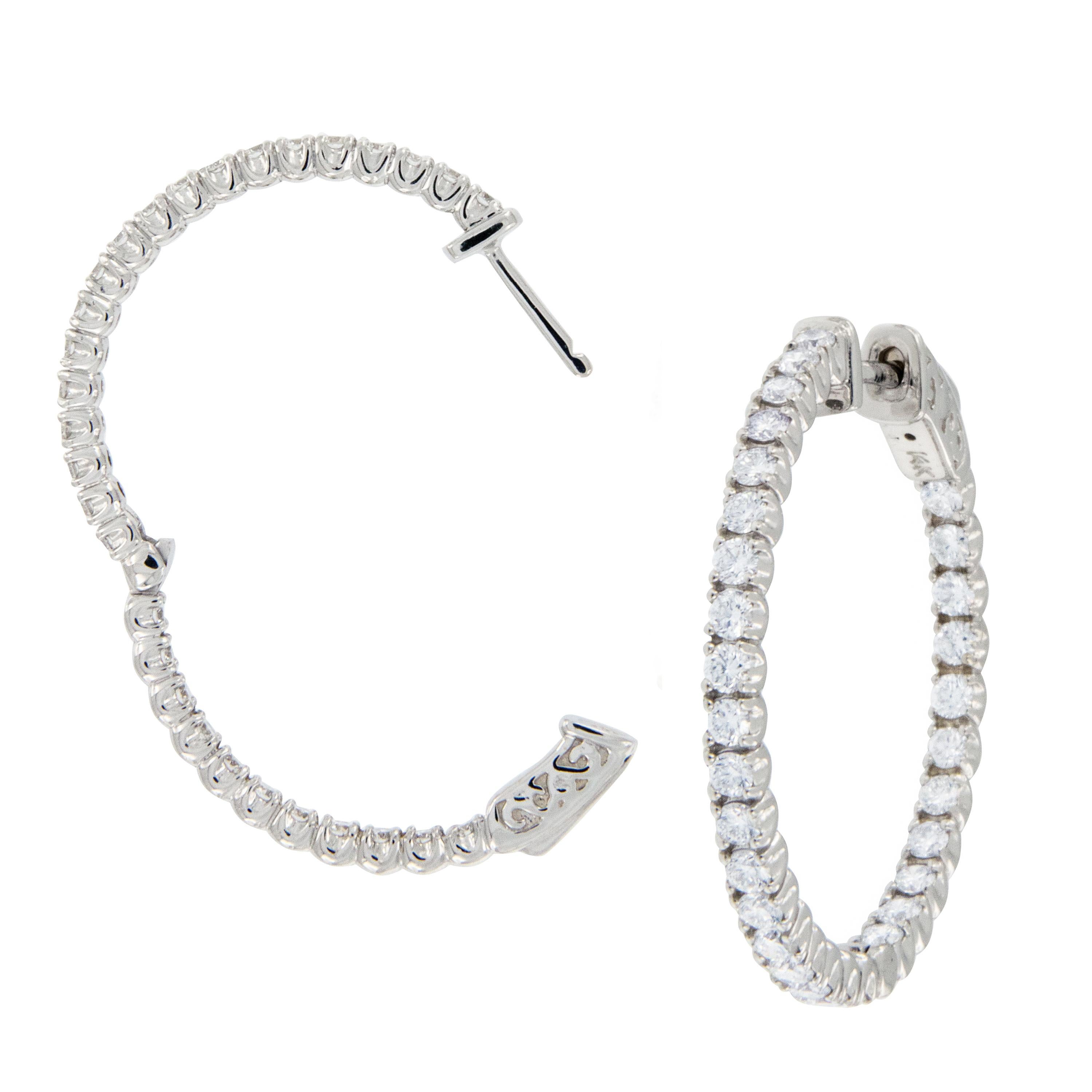 As timeless and classic as they get - these 14 karat white gold round diamond hoop earrings with 1.76 Cttw VS, F-G diamonds sparkle from front to back in the inside / outside style! Expertly crafted with hinge & locking backs for security of wear,