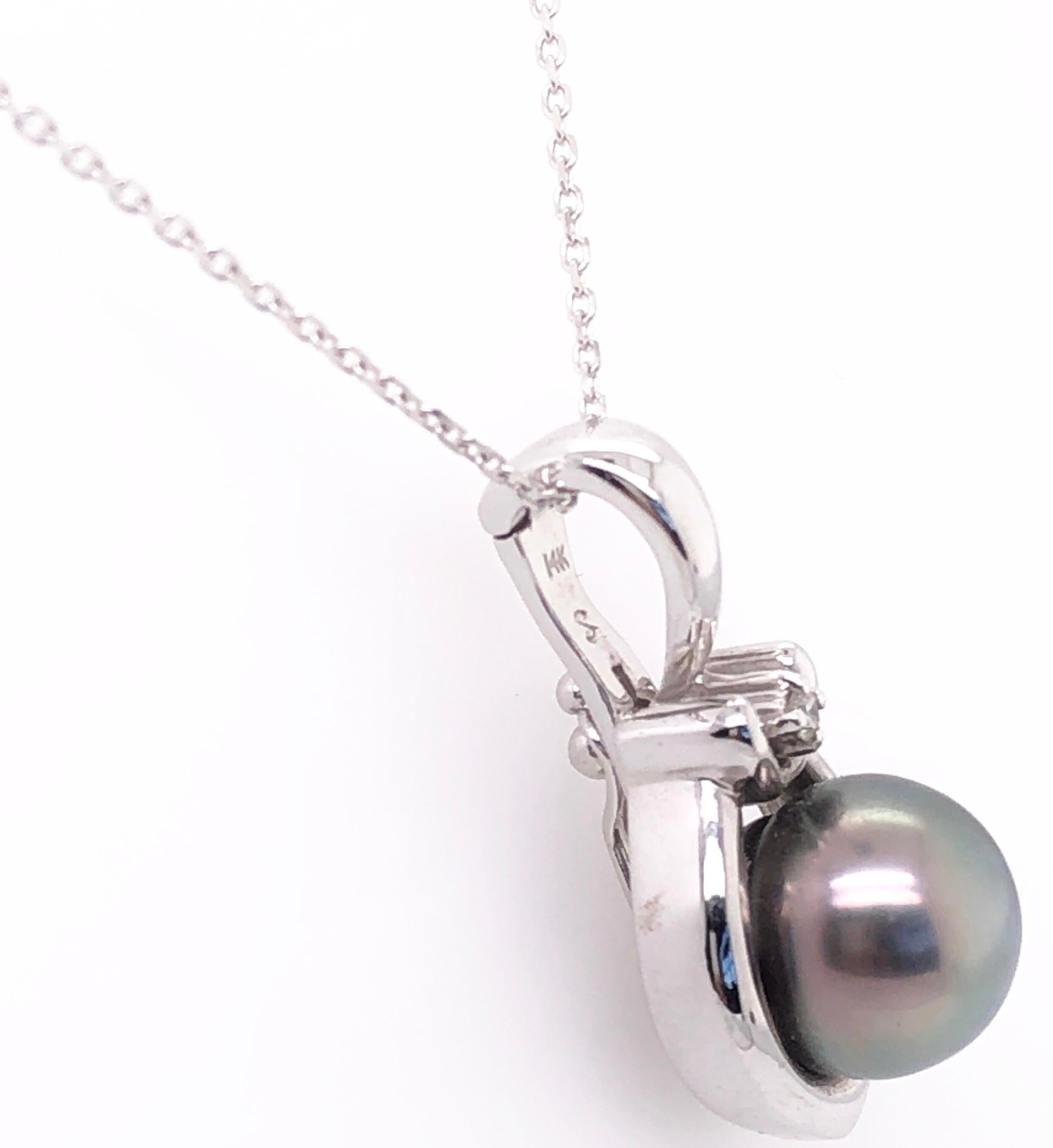 14 Karat White Gold 18 Inch Necklace with Cultured Pearl and Diamond Pendant.
6.39 grams total weight.