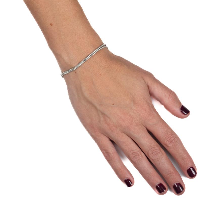 This 14 karat white gold dainty bracelet features 1.93 carat total weight in round diamonds set in two rows. Box clasp with double safety closure. The length is 7