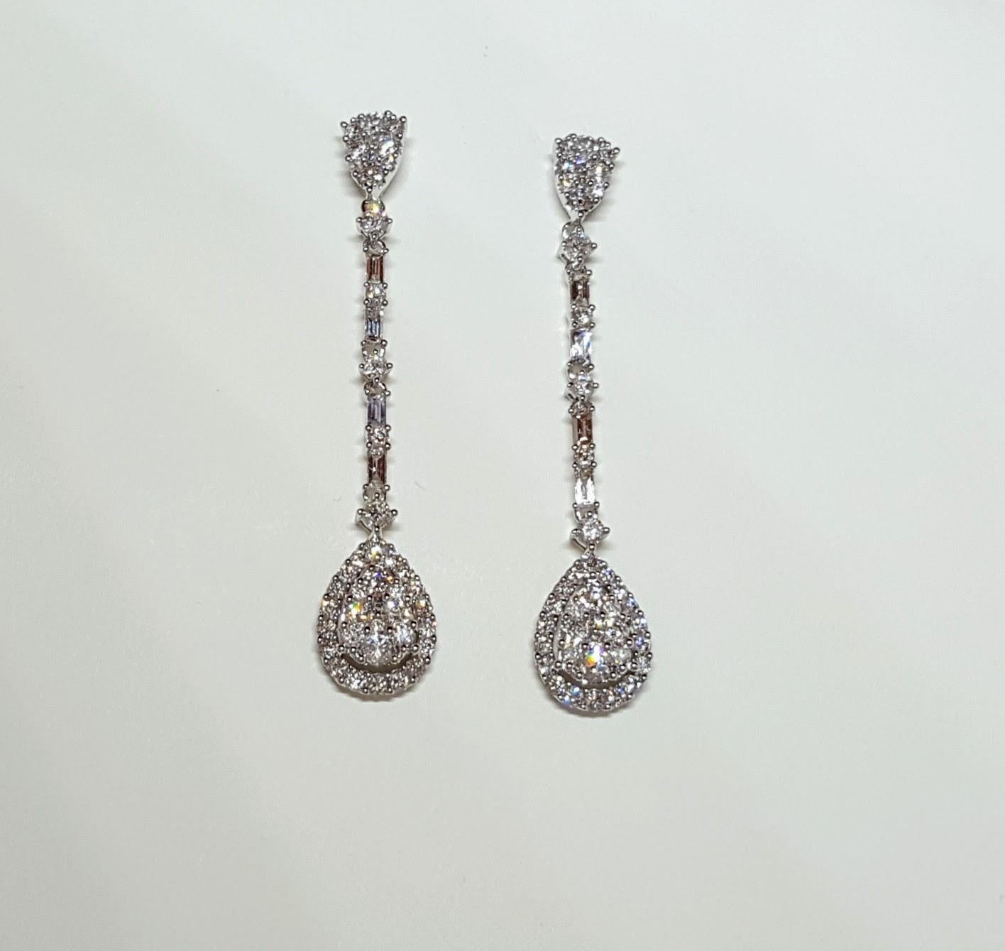 These Round and Baguette Diamond Drop Earrings are made in 14 karat White Gold, set with natural, colourless diamonds. With a total diamond carat weight (approximate) of 1.95 carats, The Diamonds are G colour, VS clarity. One of a Kind, ready to