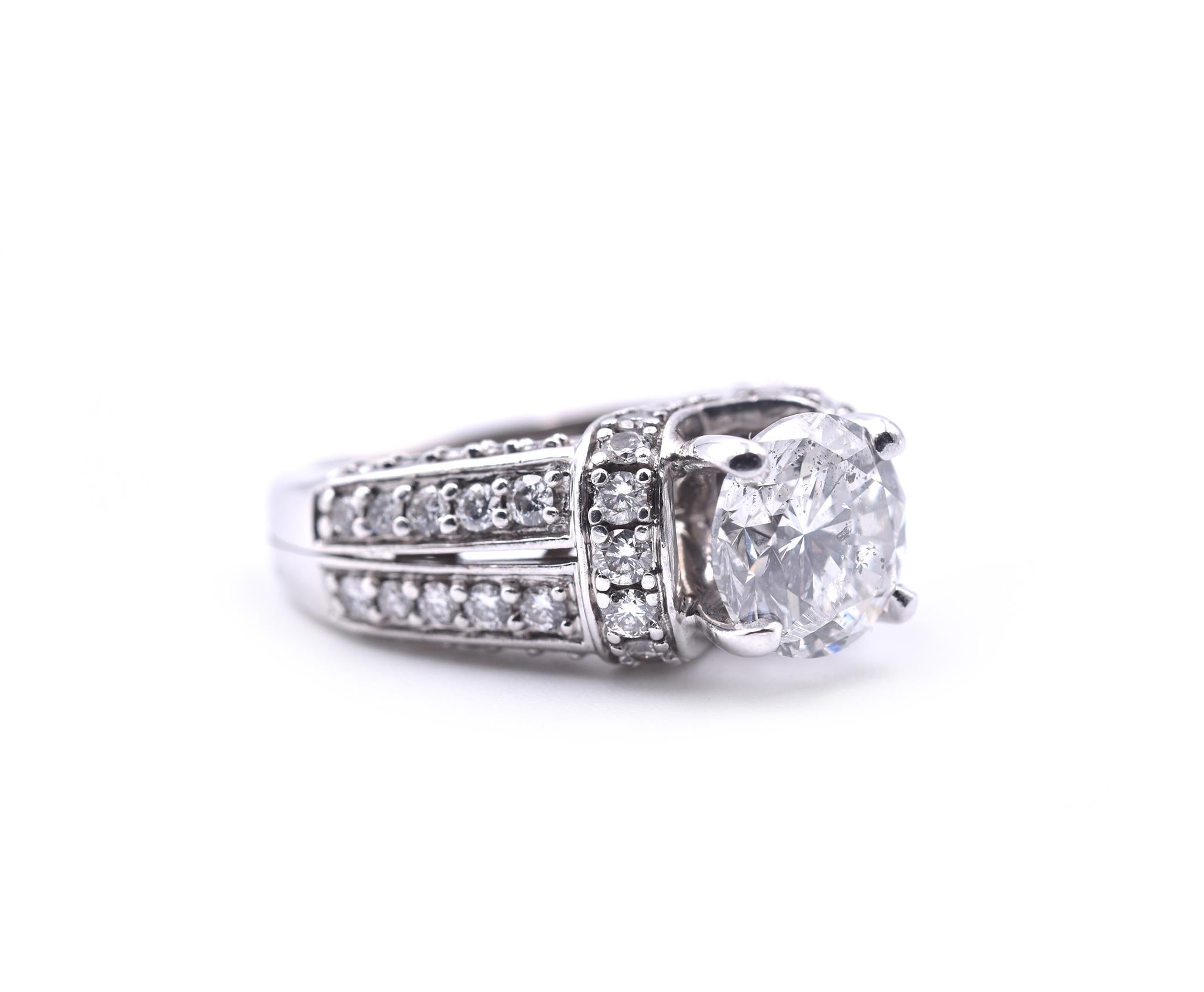 Designer: custom 
Material: 14k white gold
Center Diamond: 1 Round Brilliant Cut = 2.10ct
Color: H
Clarity: I1
Diamonds: 60 Round Brilliant Cuts = 1.00cttw H SI1
Ring Size: 4.75 (please allow two additional shipping days for sizing