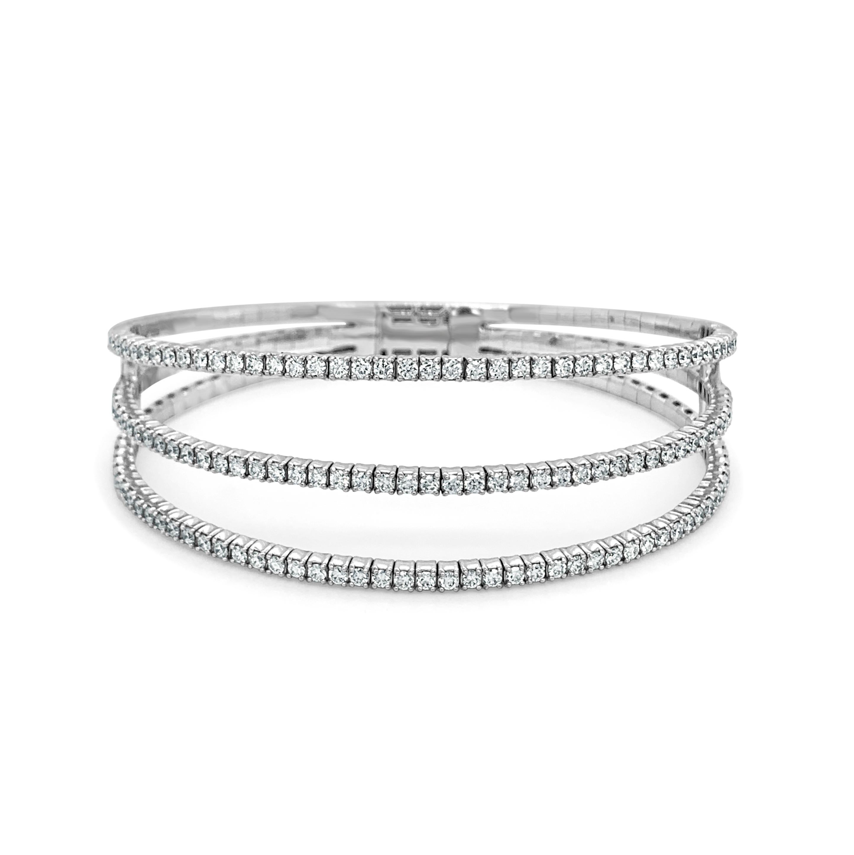 This Stunning and Striking flexible triple row bangle will be sure to add a statement to your look! Crafted of 14K Gold this bangle features 2.85 carats of Natural Round White Diamonds. 7