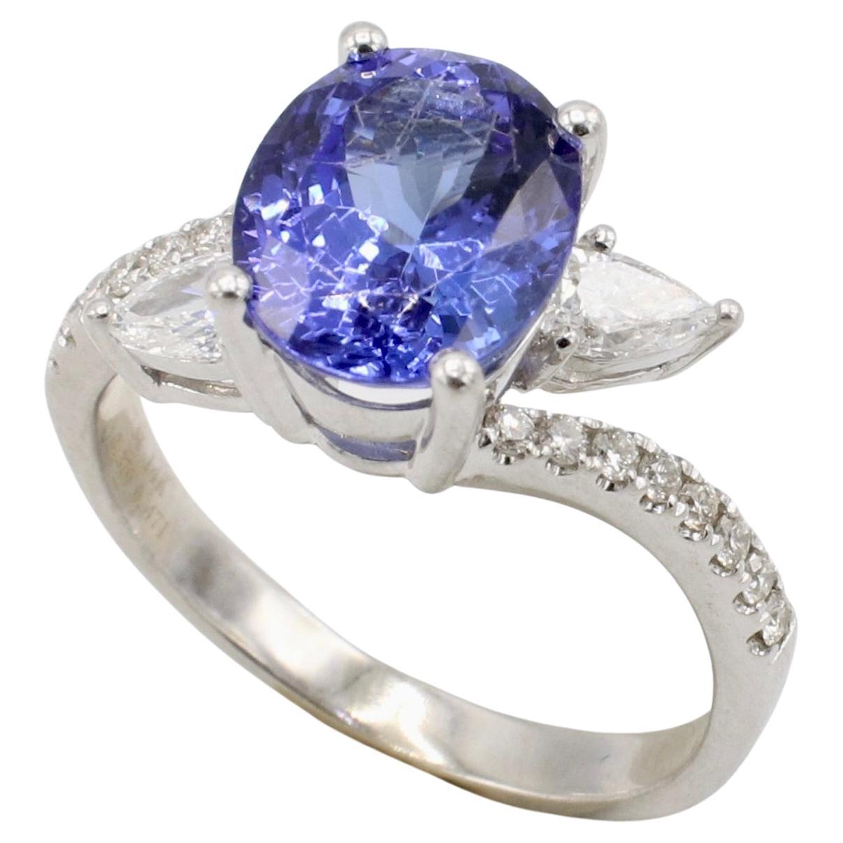 14 Karat White Gold 3.37 Carat Tanzanite & Natural Diamond Cocktail Ring 
Metal: 14k white gold
Weight: 4.34 grams
Diamonds: 0.471 CTW natural round and pear shape diamonds F-G VS 
Tanzanite: Oval, 3.37 carats 9.8 x 8.1mm
Height: 7.5mm
Size: 7.5