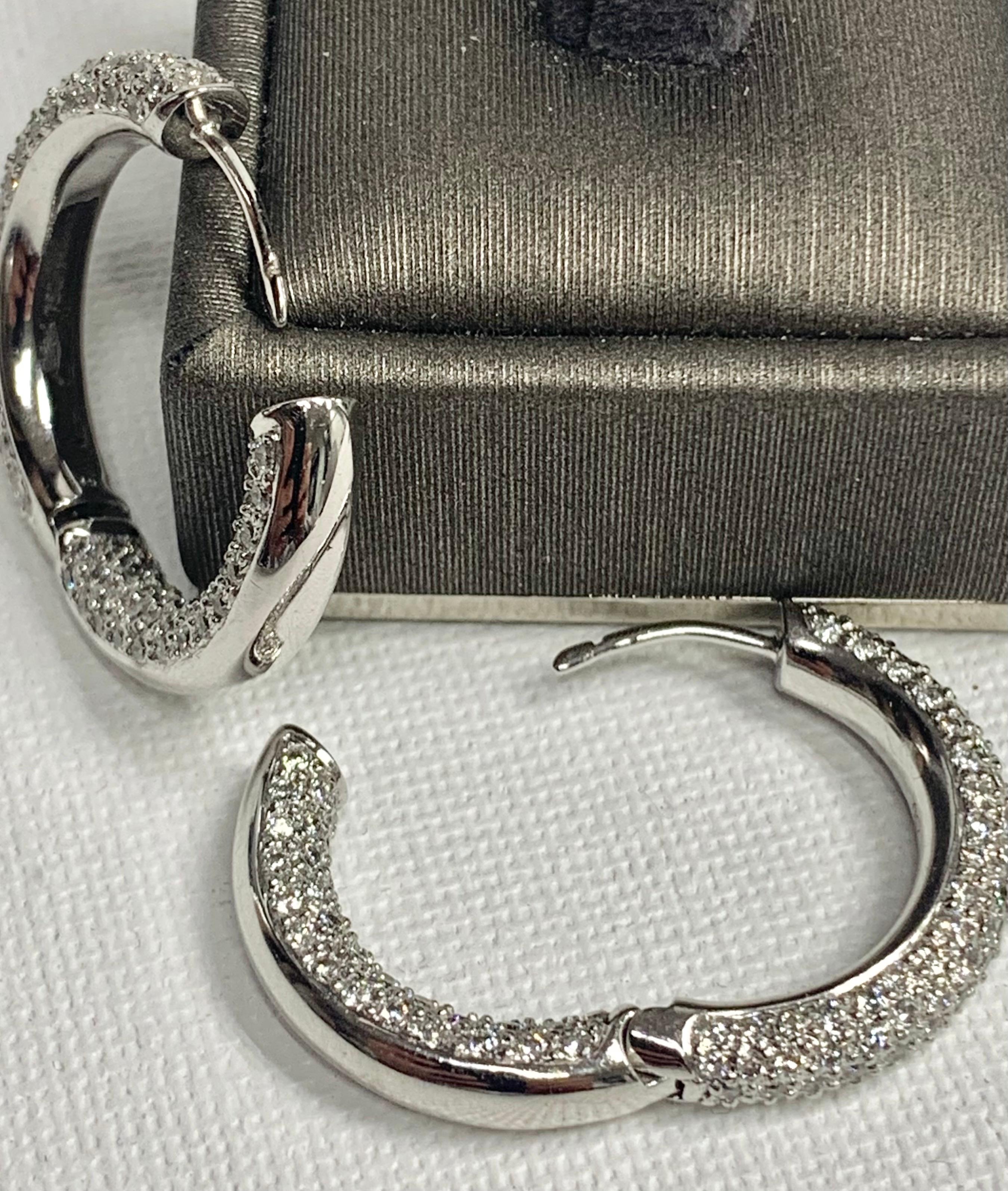 Pavé Diamond, White Gold Hoop Earrings, Art Nouveau. 

Featuring a pair of White Pavé Diamond earrings with a total weight of 4.07 carats, set in 14K White Gold.

This one-of-a-kind pair of earrings was created by hand and in CAD, Computer Aided