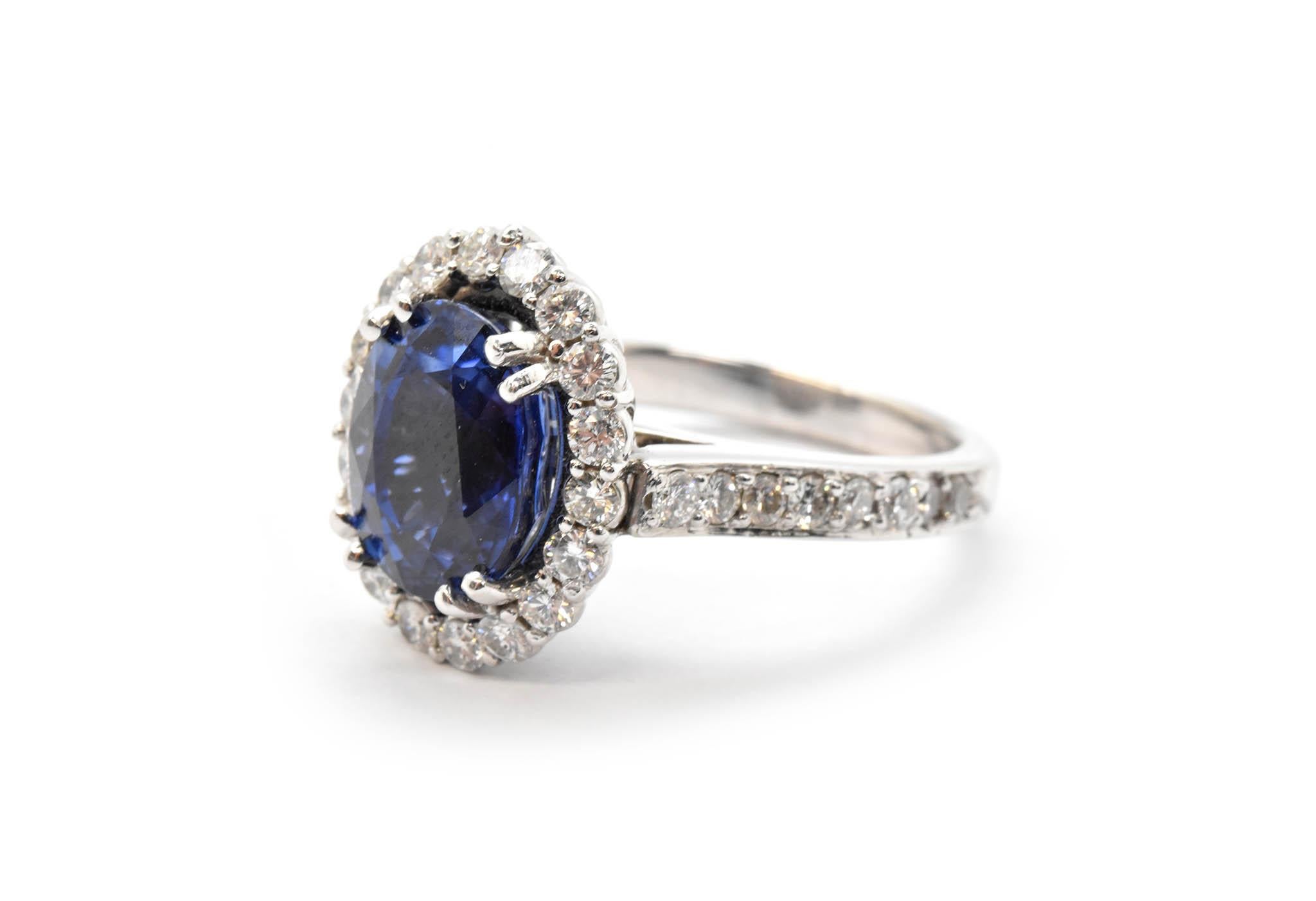 Modern 14 Karat White Gold, 5.31 Carat Oval Sapphire and 1.26 Carat Diamond Halo Ring