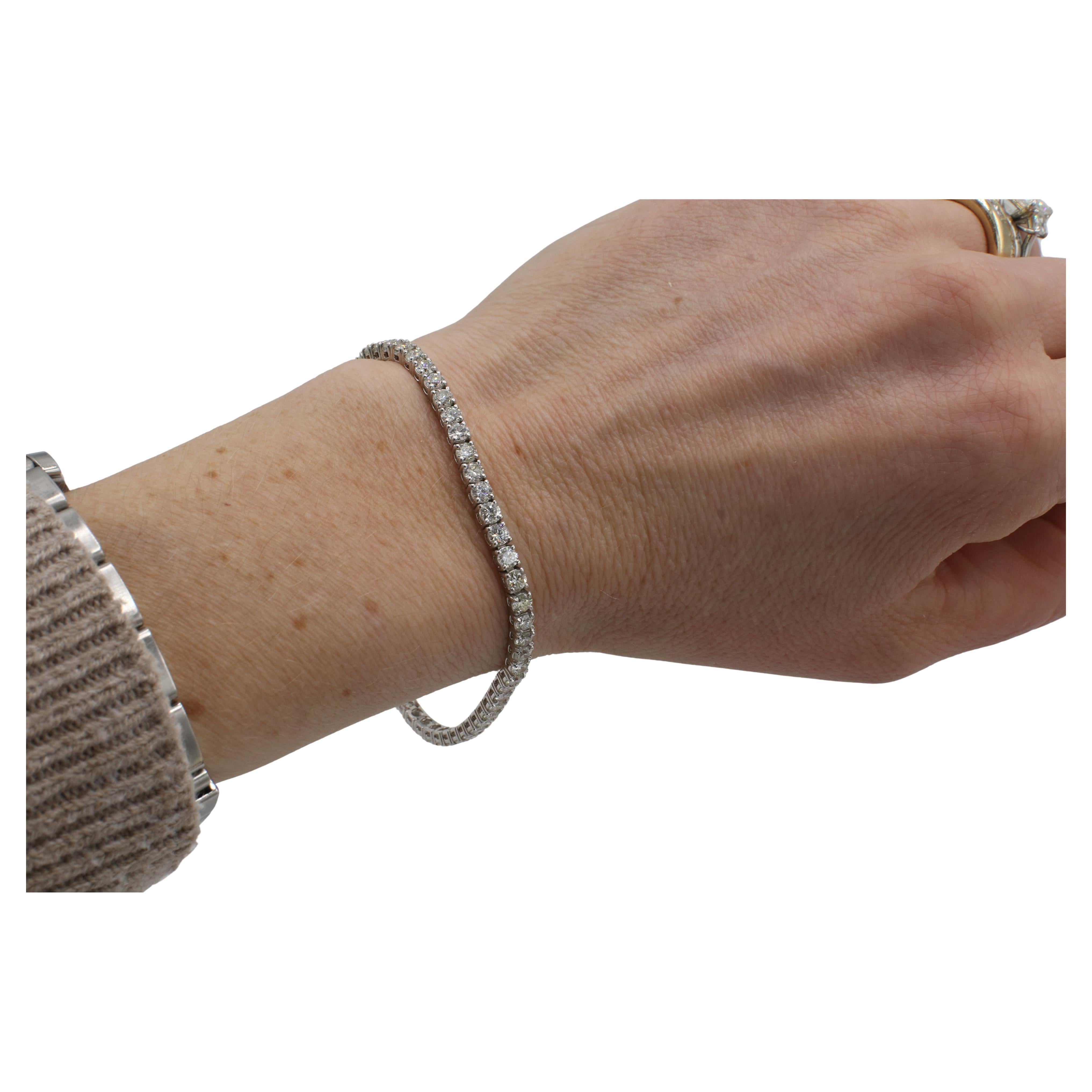 14 Karat White Gold 5.82 Carat Natural Diamond Tennis Line Bracelet 
Metal: 9.6 grams
Diamonds: 53 round brilliant natural diamonds, 5.82 CTW I-J SI-I1
Length: 7 inches
Width: 3mm
RADD 111241-2