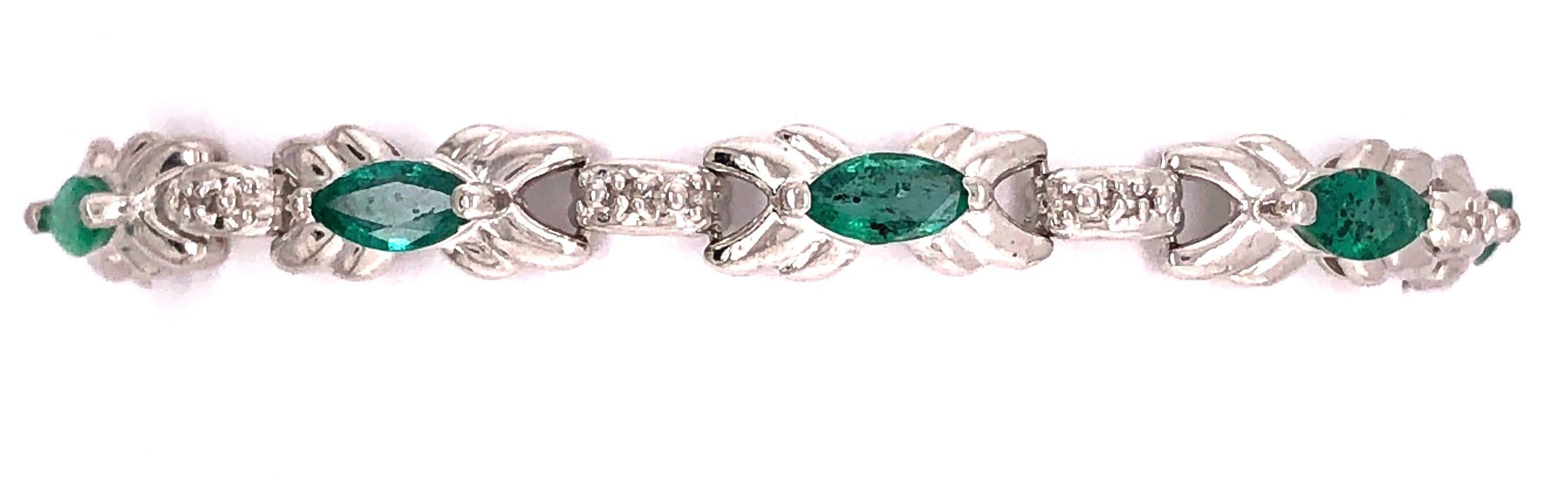 14 Karat White Gold 7 Inch Emerald Bracelet with Round Diamonds.
11.7 grams total weight.

