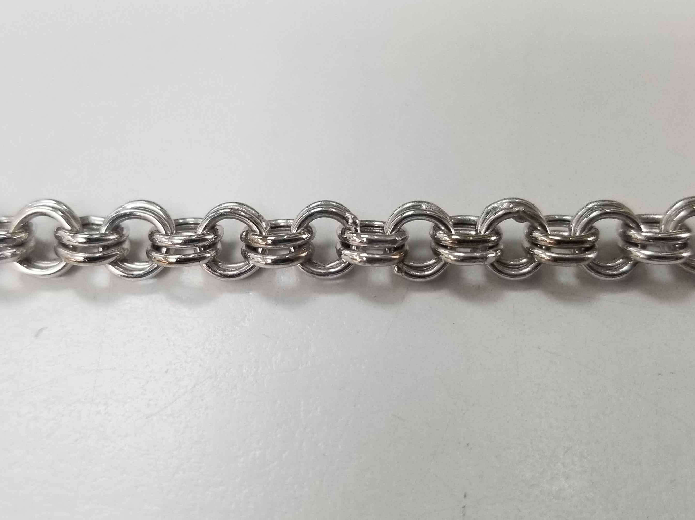 14 karat white gold 7.25 inch 5.5mm double charm link bracelet weighing 7.4 grams.