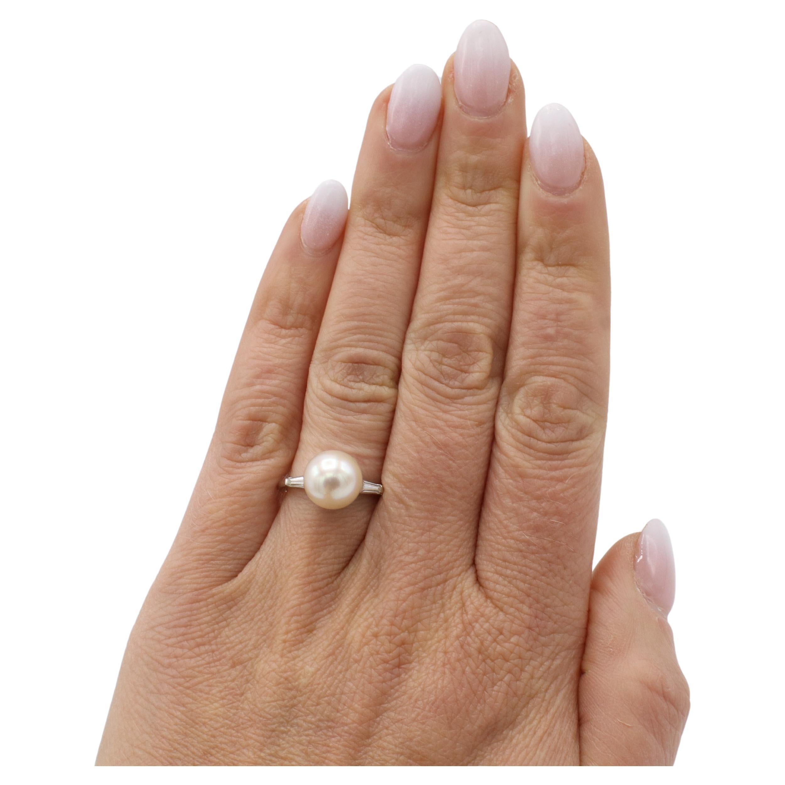 14 Karat White Gold Akoya Cultured Pearl & Natural Diamond Cocktail Ring 
Metal: 14k white gold
Weight: 3.25 grams
Pearl: 9.5mm cultured white pearl with creamy luster
Diamonds: 2 tapered baguette natural diamonds .30 CTW G-H VS
Height: 11mm
Size: