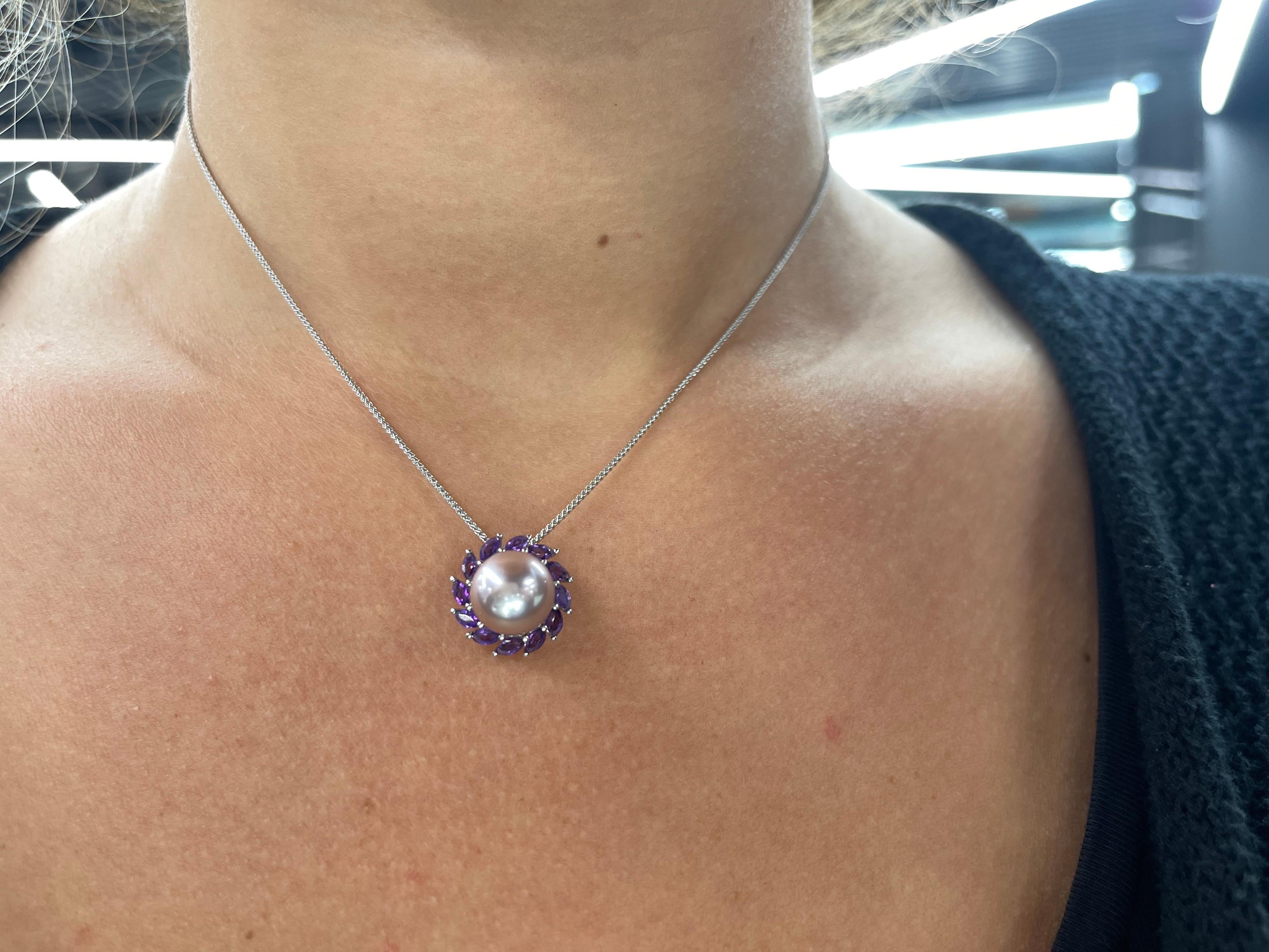14 Karat White gold pendant featuring one Pink Freshwater Pearl measuring 13-14 mm flanked with 12 Marquise cut Amethyst weighing 0.91 carats.