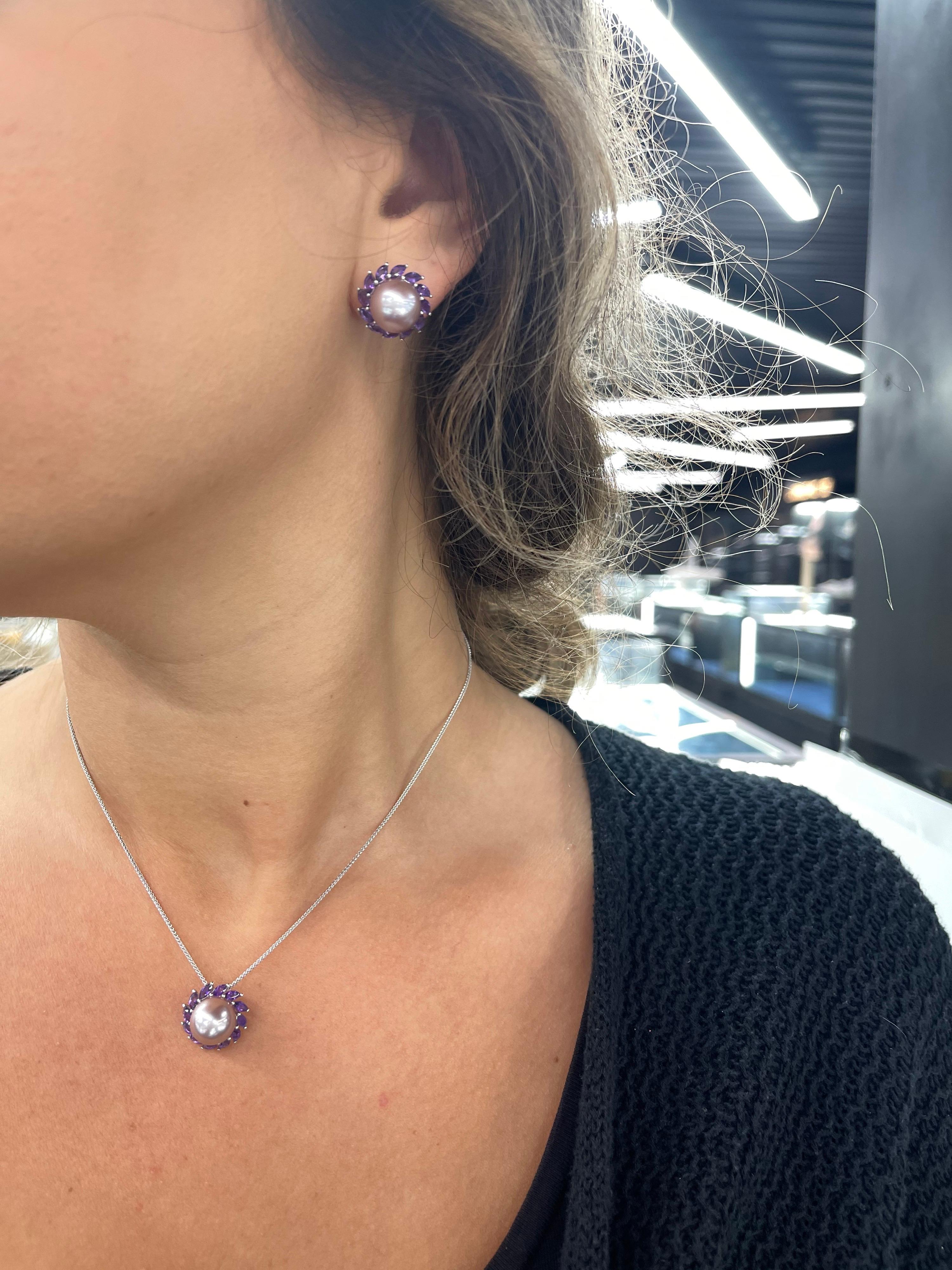 14 Karat White gold stud earrings featuring two Pink Freshwater Pearls measuring 10-11 mm flanked with marquise shape Amethysts weighing 1.81 carats.
Matching Necklace In Stock.