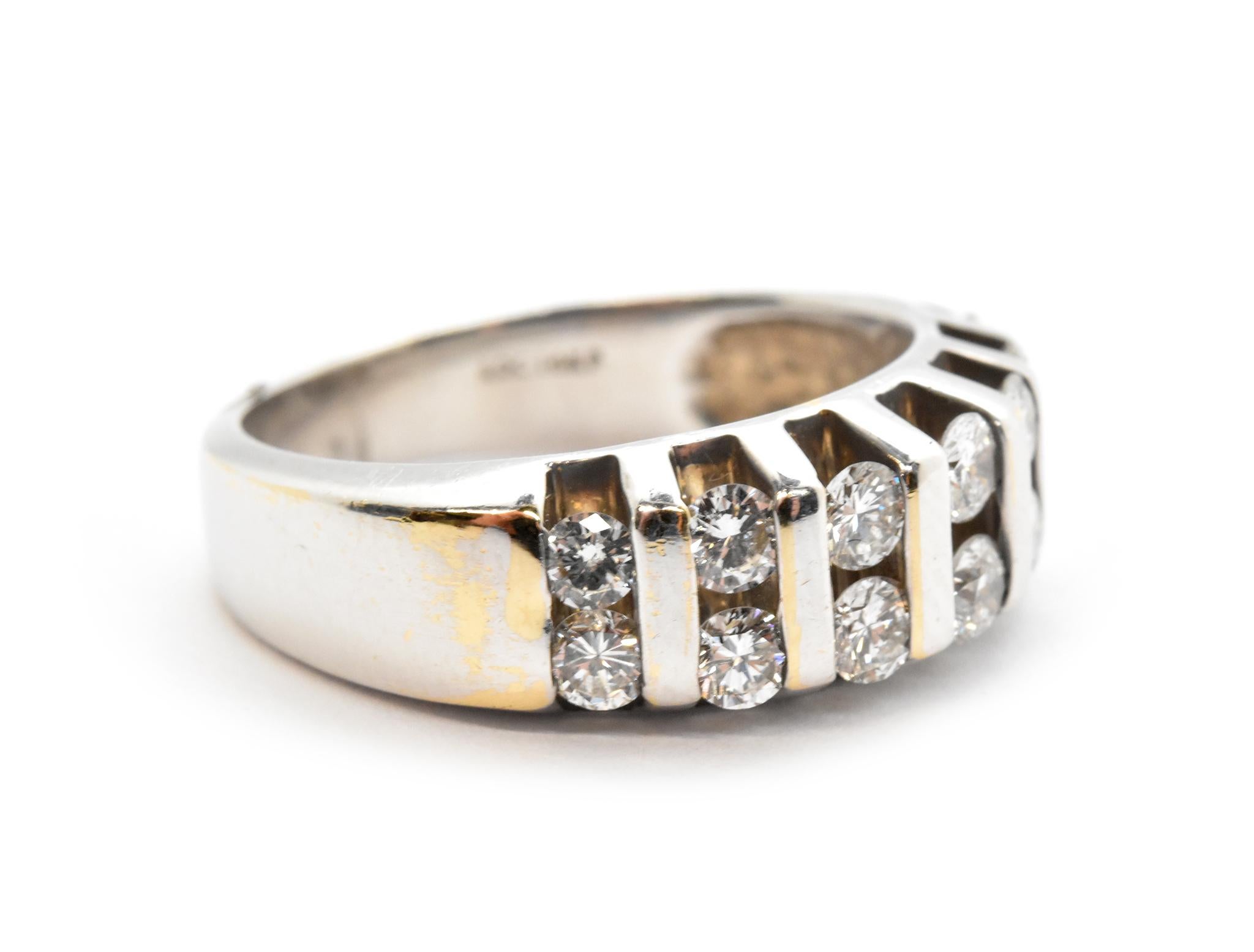 This stunning band is made in 14k white gold, and it features rows of channel-set diamonds for a total weight of 1.00 carat. The diamonds are graded G-H in color and SI in clarity. The band measures 7mm wide, and it weighs 7.14 grams. It is size