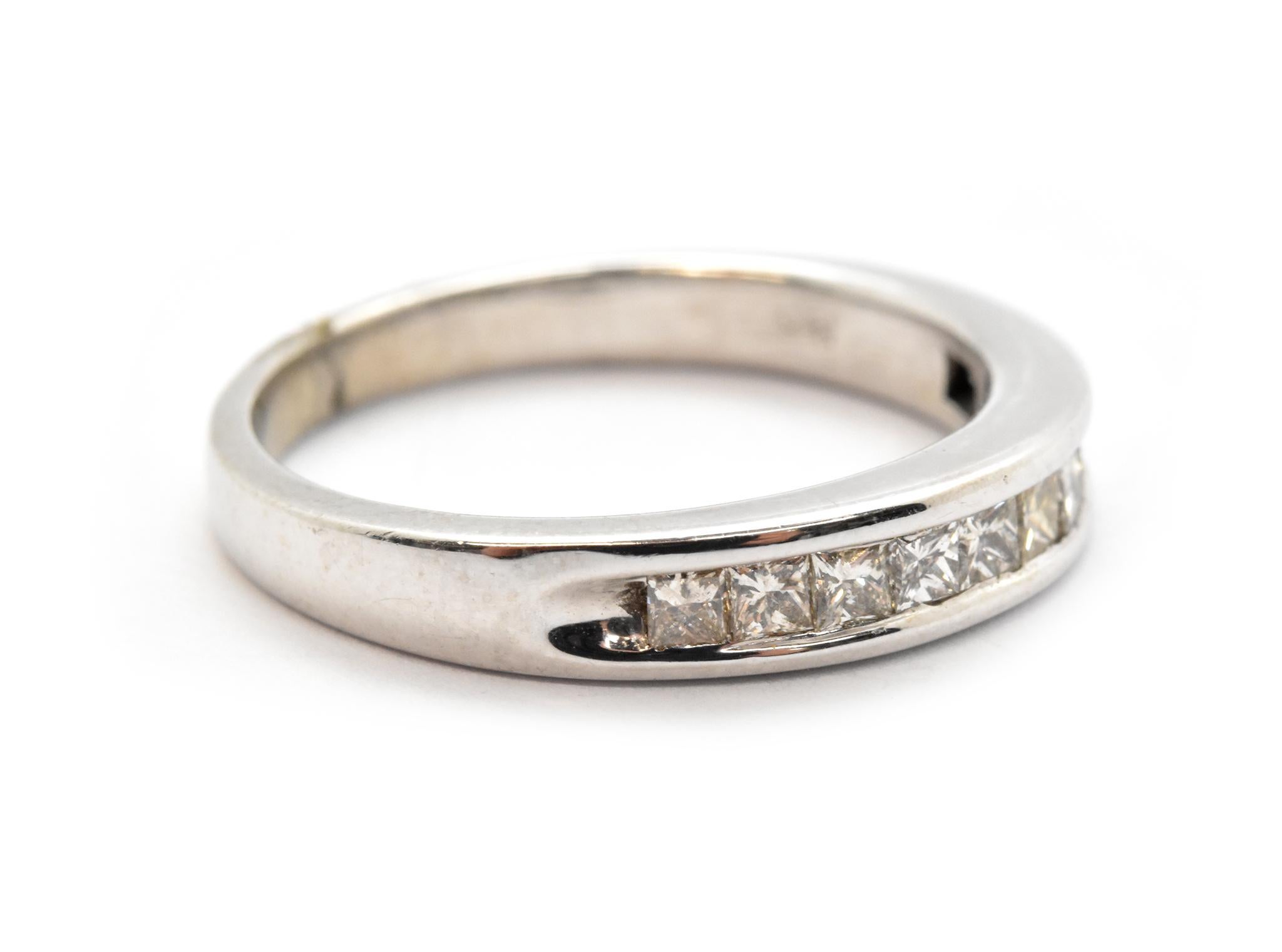 This band features a row of channel-set, princess-cut diamonds set into 14k white gold. The diamonds have a total weight of 0.50ct, and they are graded I in color and SI in clarity. The band measures 4mm wide, and it weighs 3.5 grams. It is size 7.