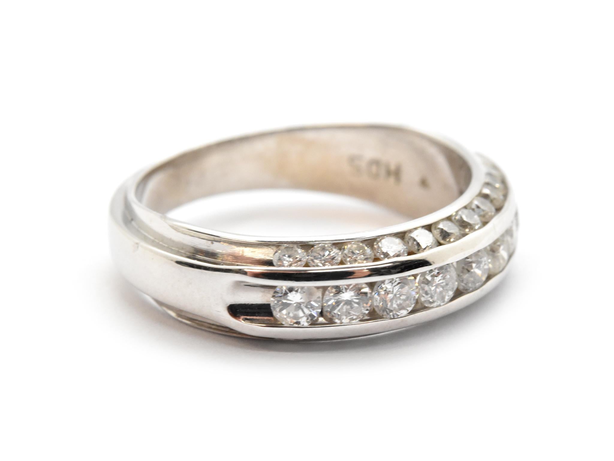 This contemporary band features a row of larger round diamonds accented by two rows of smaller round diamonds set into 14k white gold. The diamonds have a total weight of 0.95ct, and they are graded G-H in color and VS-SI in clarity. The band