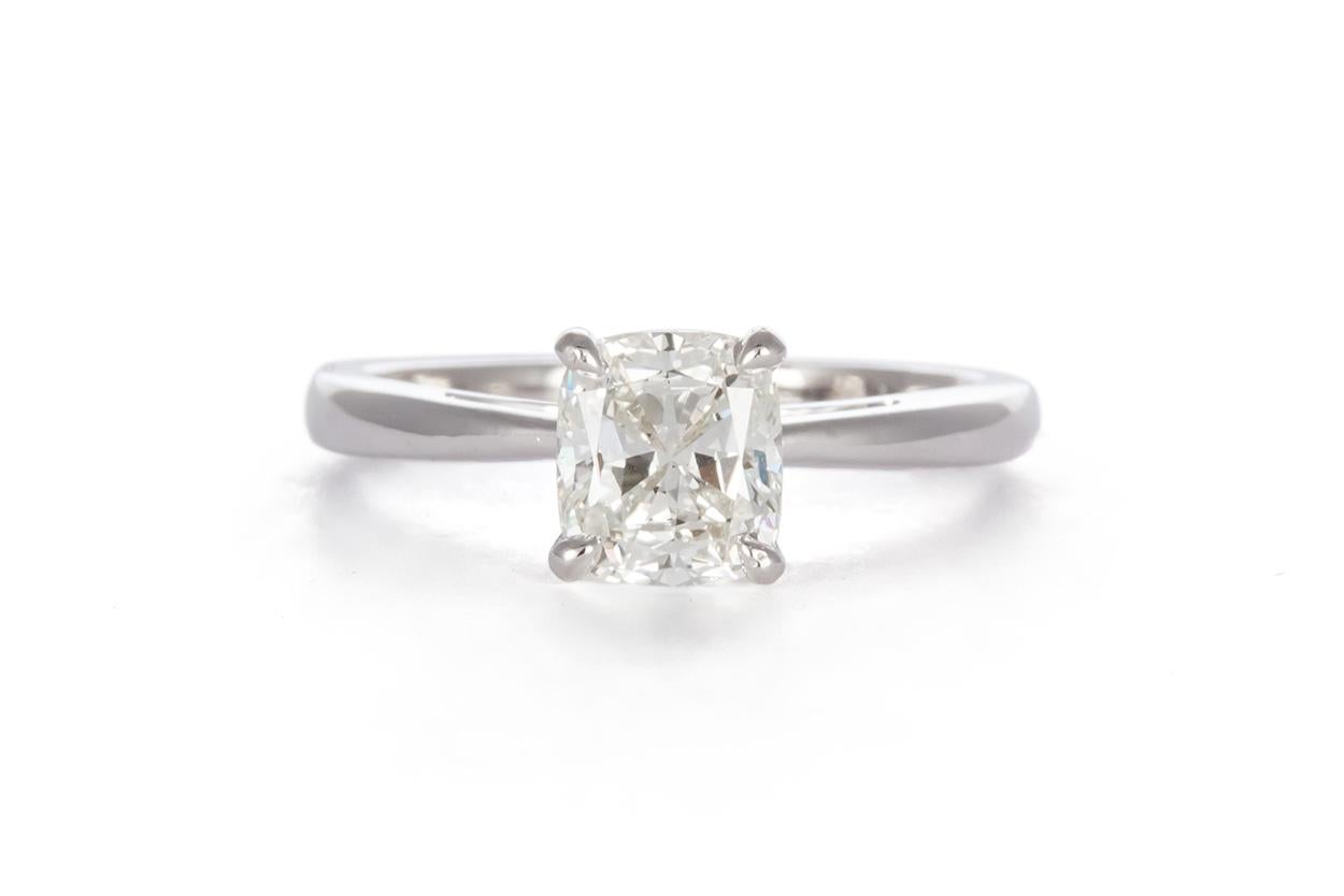 We are pleased to offer this 14K White Gold & Cushion Cut Diamond Solitaire Engagement Ring. This beautiful ring features a 1.12ct J/VS2 cushion cut diamond set in a 14k white gold solitaire setting. It is a size 5.75. The diamond is available with