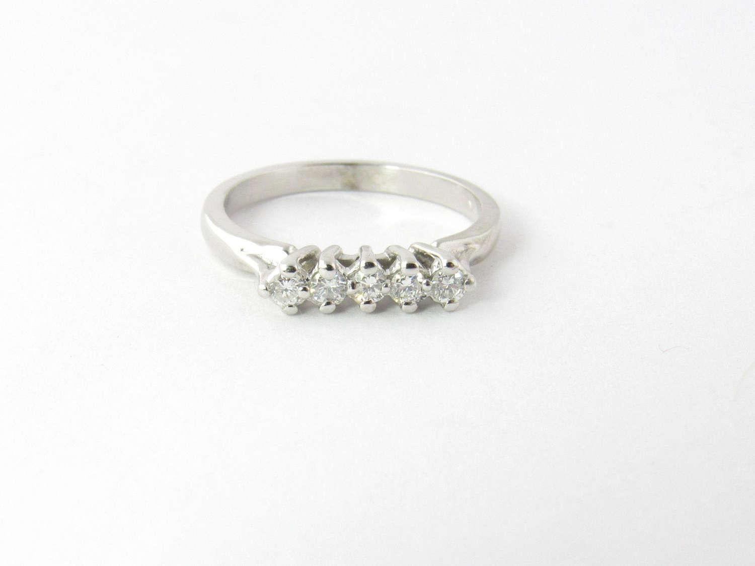 Vintage 14K White Gold and Diamond Band Size 5.5 

This high set diamond band has 5 round brilliant diamonds. 

Diamonds are approx. .15 carats in total. 

SI, H-I 

Diamonds are set approx. 4 mm high 

Shank is 2 mm wide. 

Hallmarked < FJ> 14 K