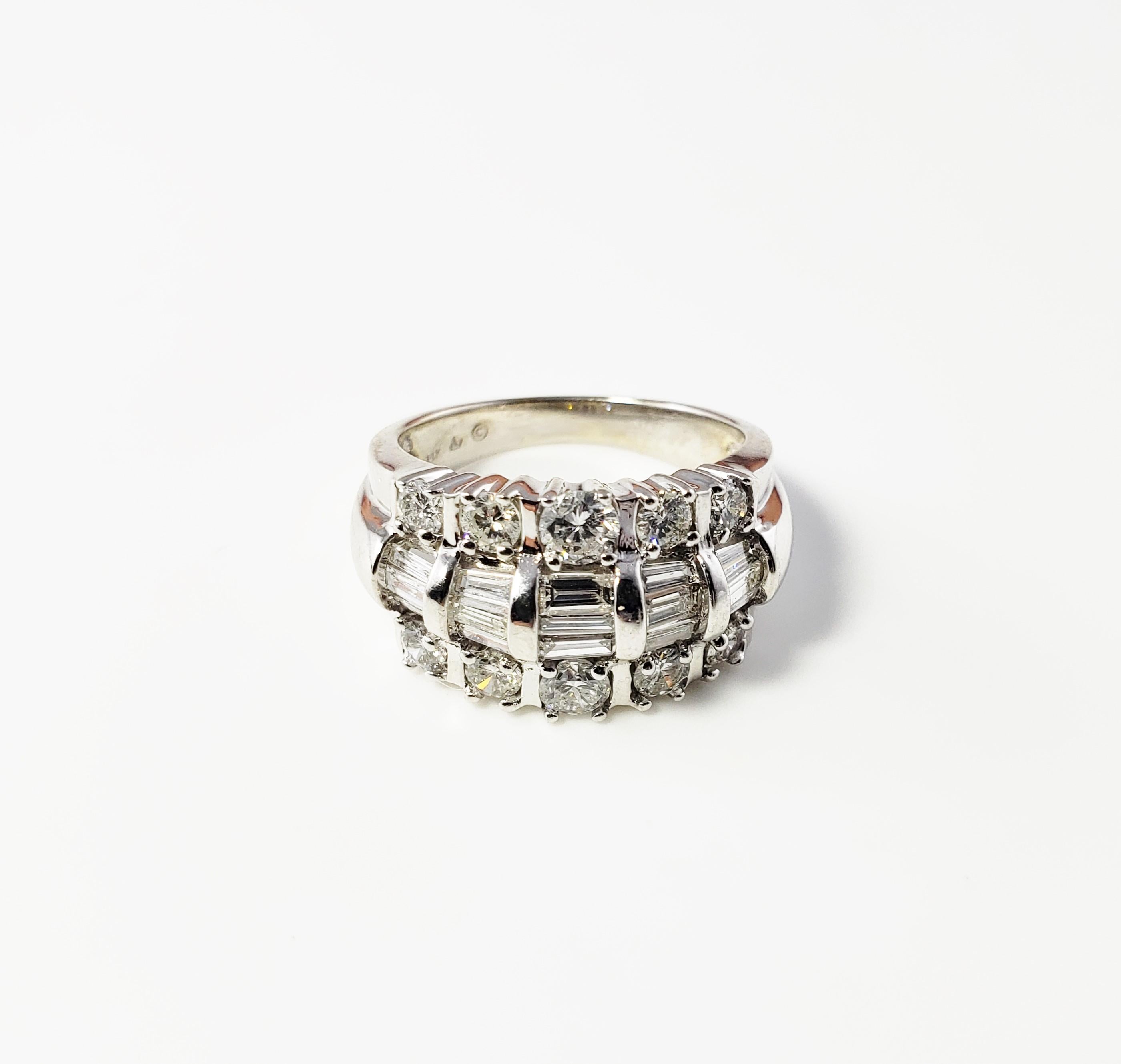 Vintage 14 Karat White Gold and Diamond Band Size 7-

This spectacular ring features 15 baguette diamonds (.45 ct. twt.) and ten round brilliant cut diamonds (.82 ct. twt.) set in beautifully detailed 14K white gold. Width: 12 mm. Shank: 3