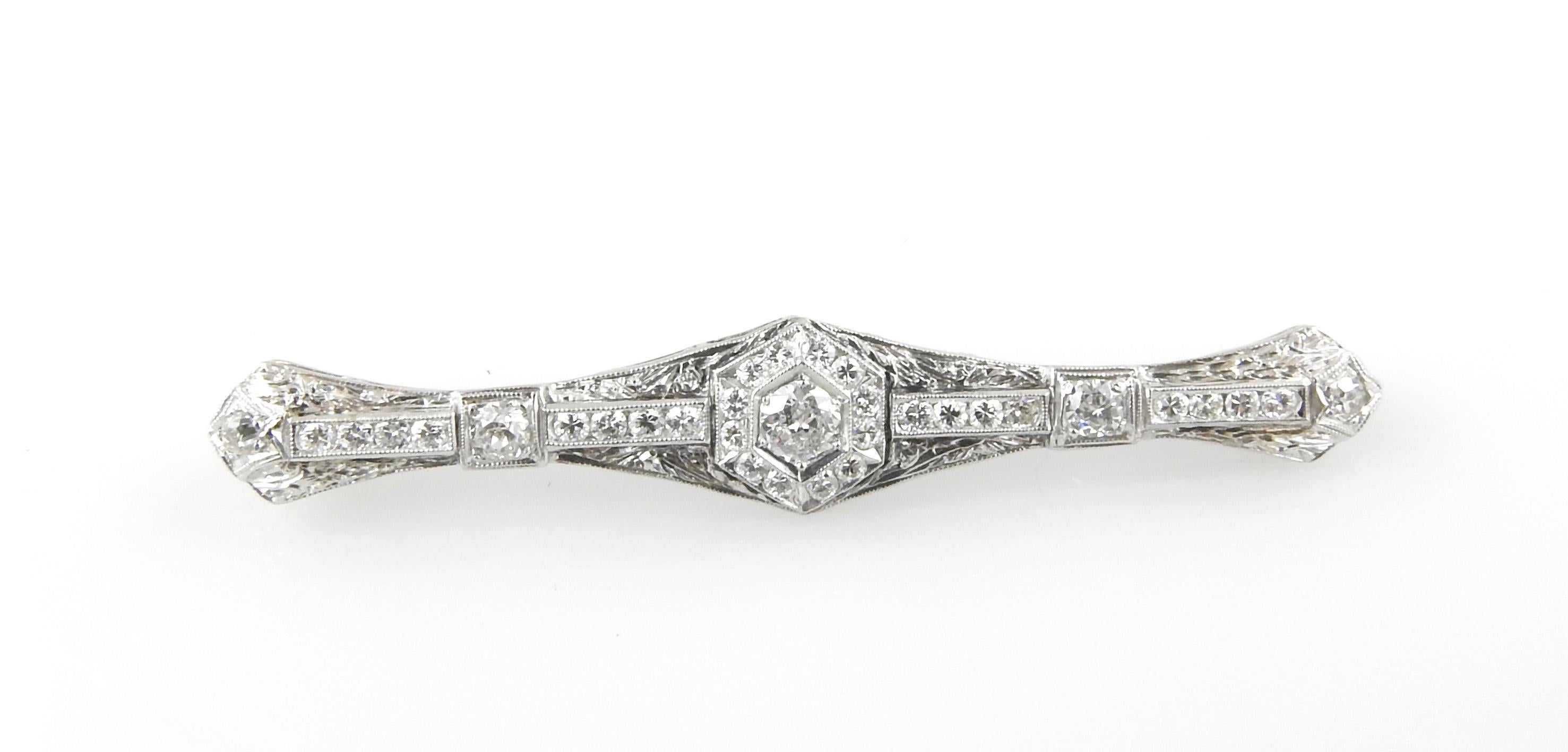 This exquisite bar pin features 33 round brilliant and old mine cut diamonds  set in beautifully detailed white  gold filigree.

Approximate total diamond weight:  1.40 cts.  (Center - .25 ct.)

Diamond color:  G-H

Diamond clarity:  SI1-VS2

Size: 