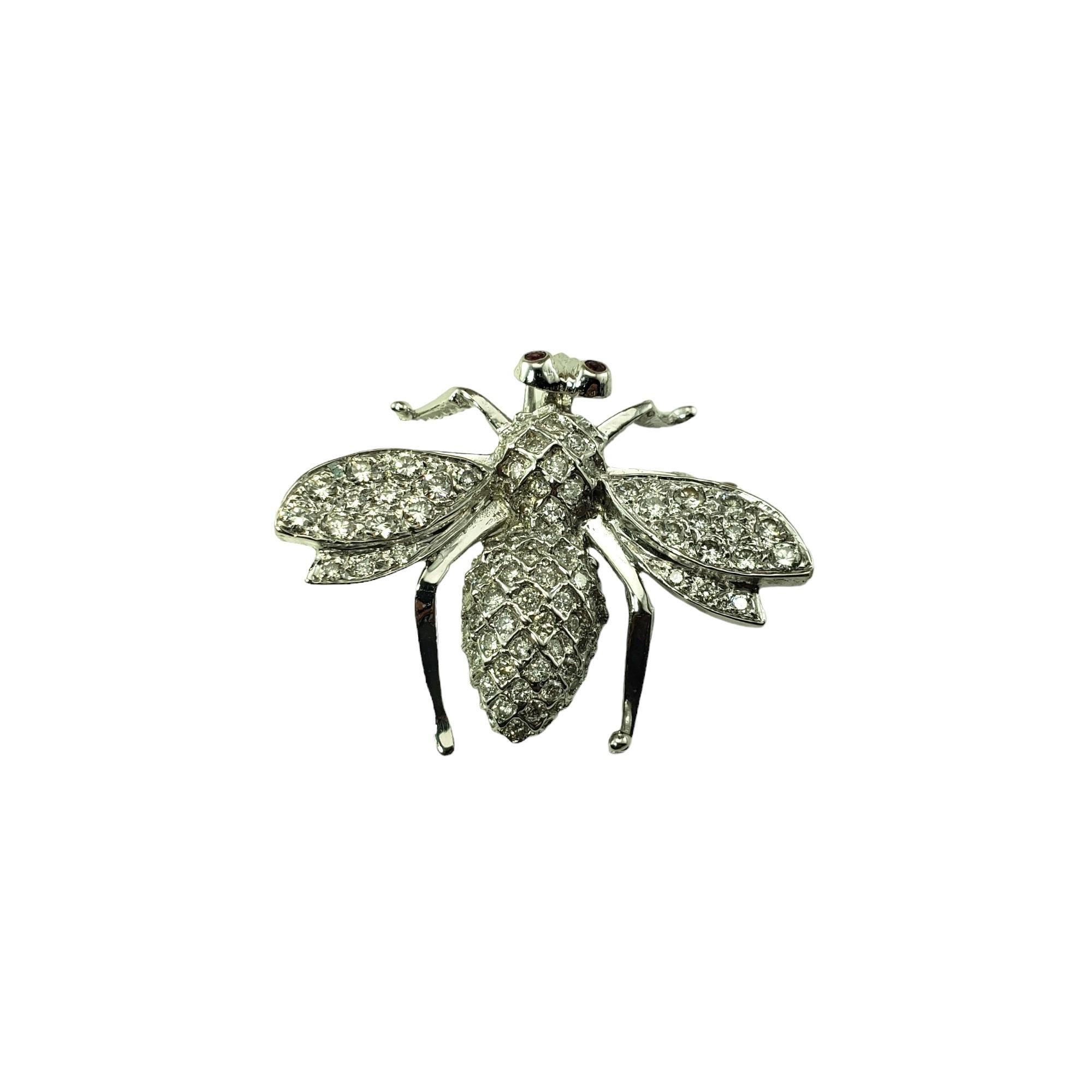 Vintage 14 Karat White Gold and Diamond Bee Brooch/Pin-

This sparkling bee brooch features 93 round brilliant cut diamonds set in beautifully detailed 14K white gold.  Accented with two red faceted eyes.

Approximate total diamond weight:  1.10