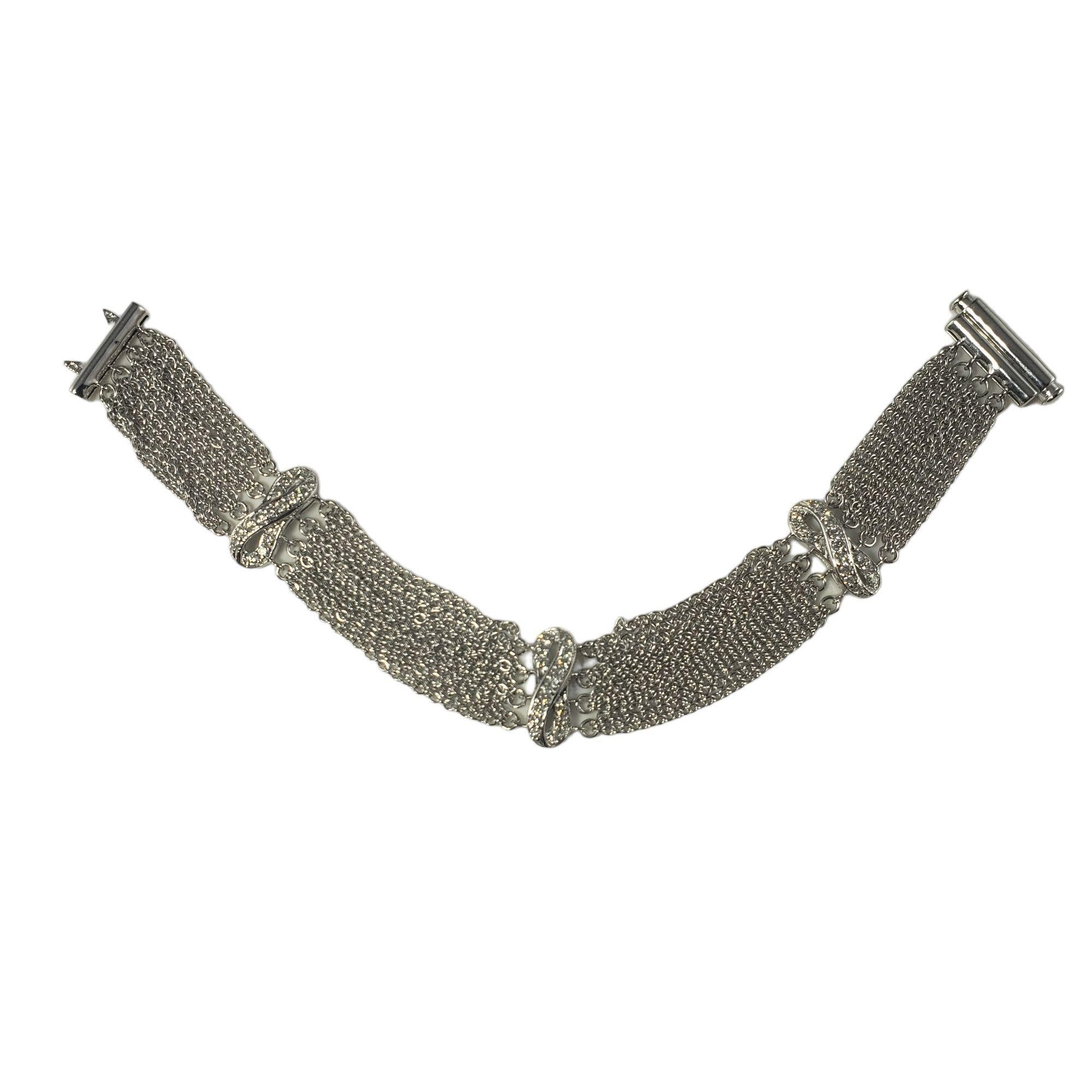 Vintage 14 Karat White Gold and Diamond Bracelet-

This sparkling bracelet features 45 round brilliant cut diamonds set in beautifully detailed 14K white gold. Width: 15 mm.

Approximate total diamond weight: .90 ct.

Diamond clarity:
