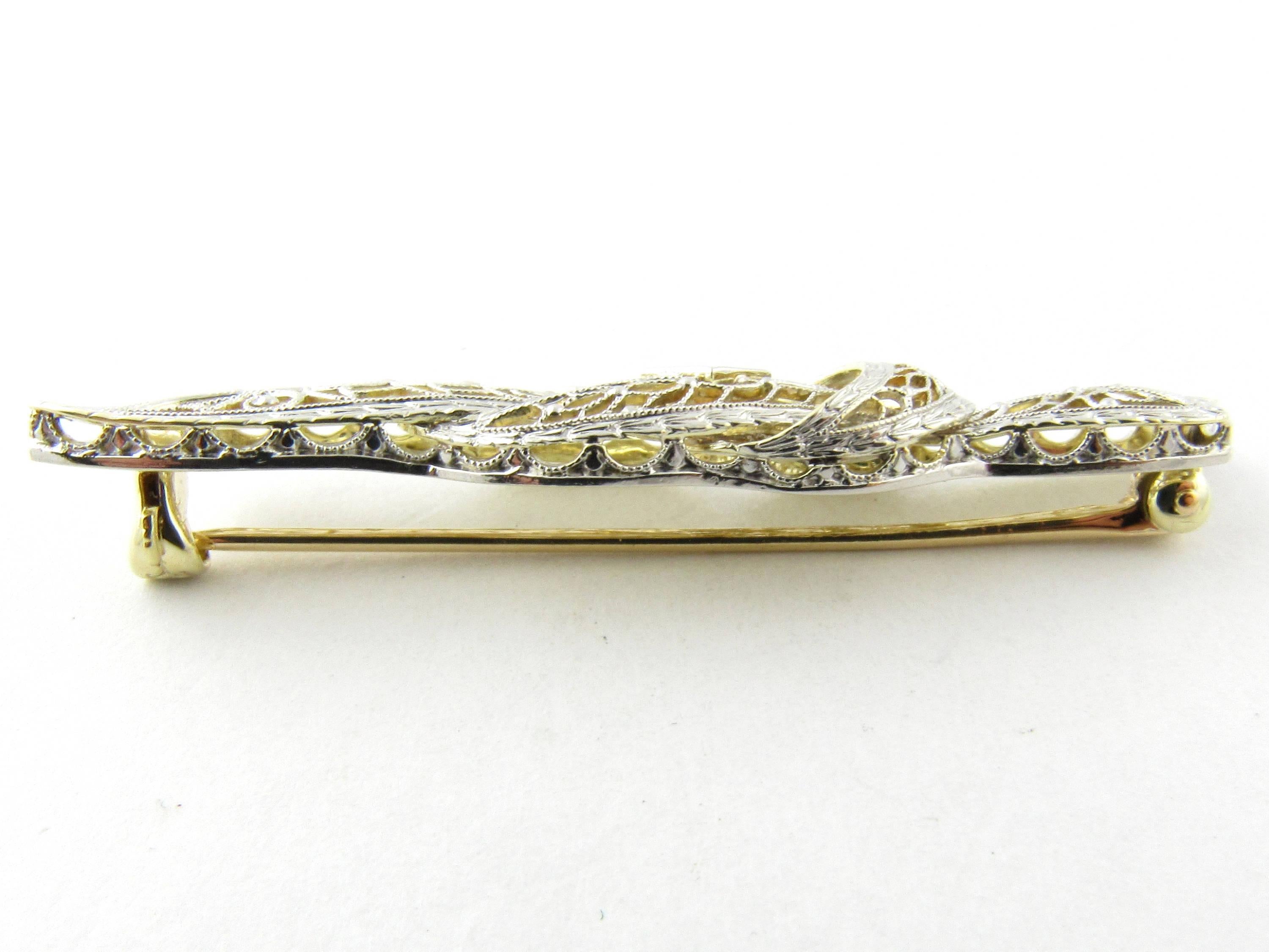Vintage 14 Karat White and Yellow Gold and Diamond Brooch/Pin-

This exquisite brooch features a delicate white and yellow filigree bow accented with one round brilliant cut diamond. Back of the brooch is yellow gold

Approximate total diamond