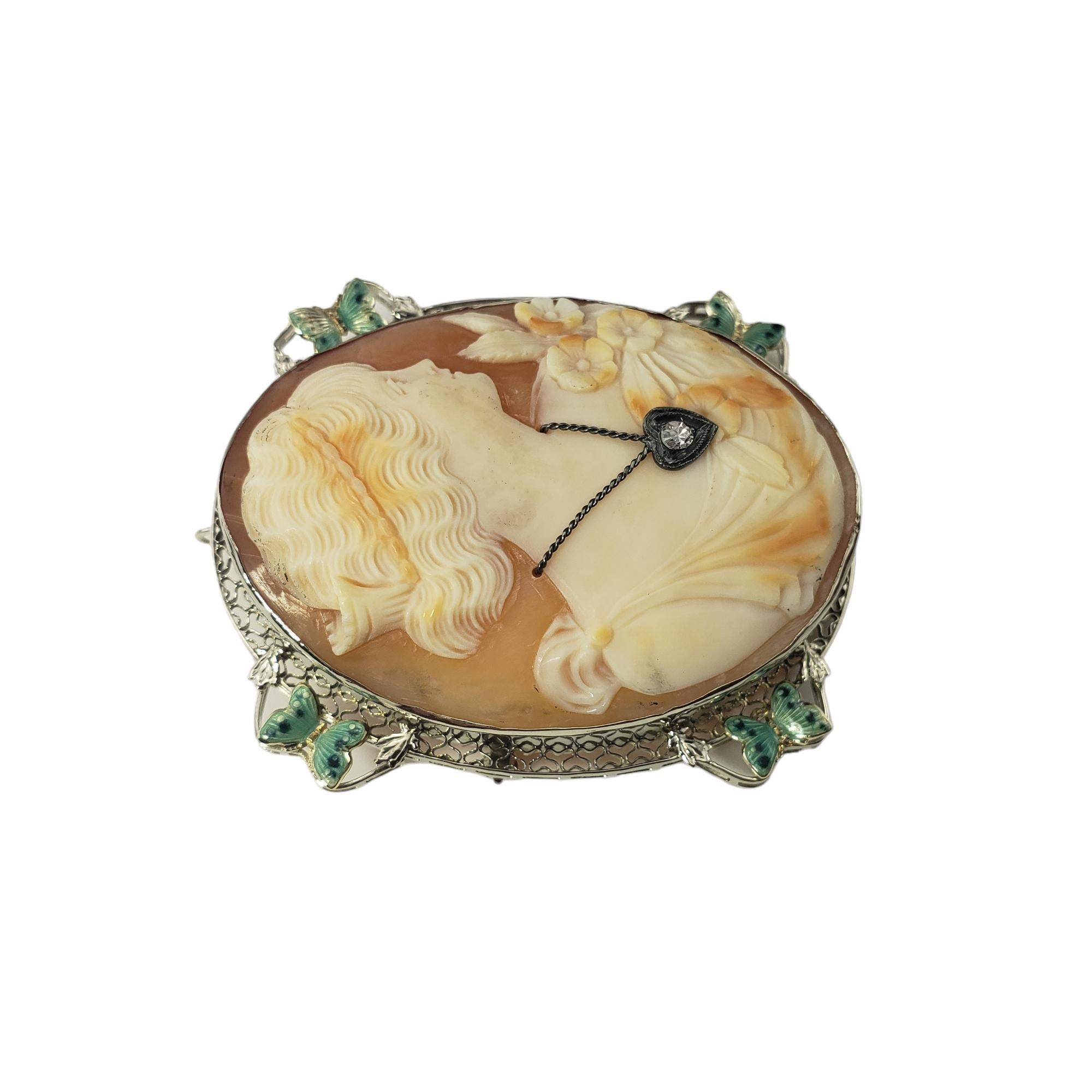 14 Karat White Gold and Diamond Cameo Brooch/Pendant-

This elegant cameo brooch features a lovely lady in profile set in beautifully detailed 14K white gold filigree.  Accented with one round single cut diamond.*
*Chip noted to stone not visible to