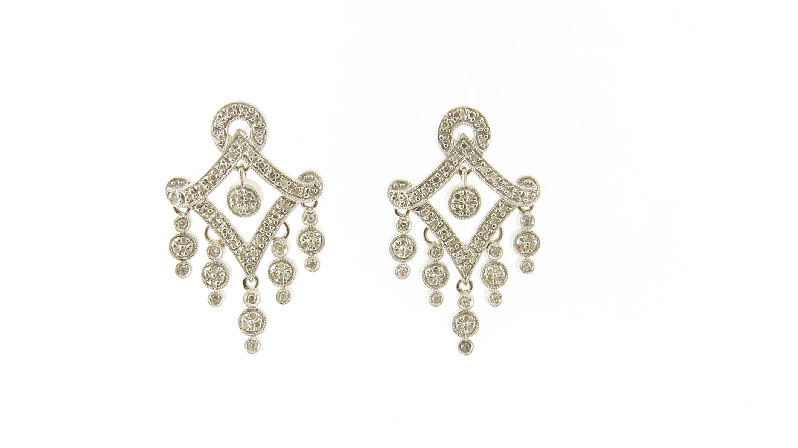 Vintage 14 Karat White Gold and Diamond Chandelier Earrings

These sparkling chandelier earrings each feature 59 single-cut diamonds set in classic 14K white gold. Push back closures.

Approximate total diamond weight: .60 ct.

Diamond color: