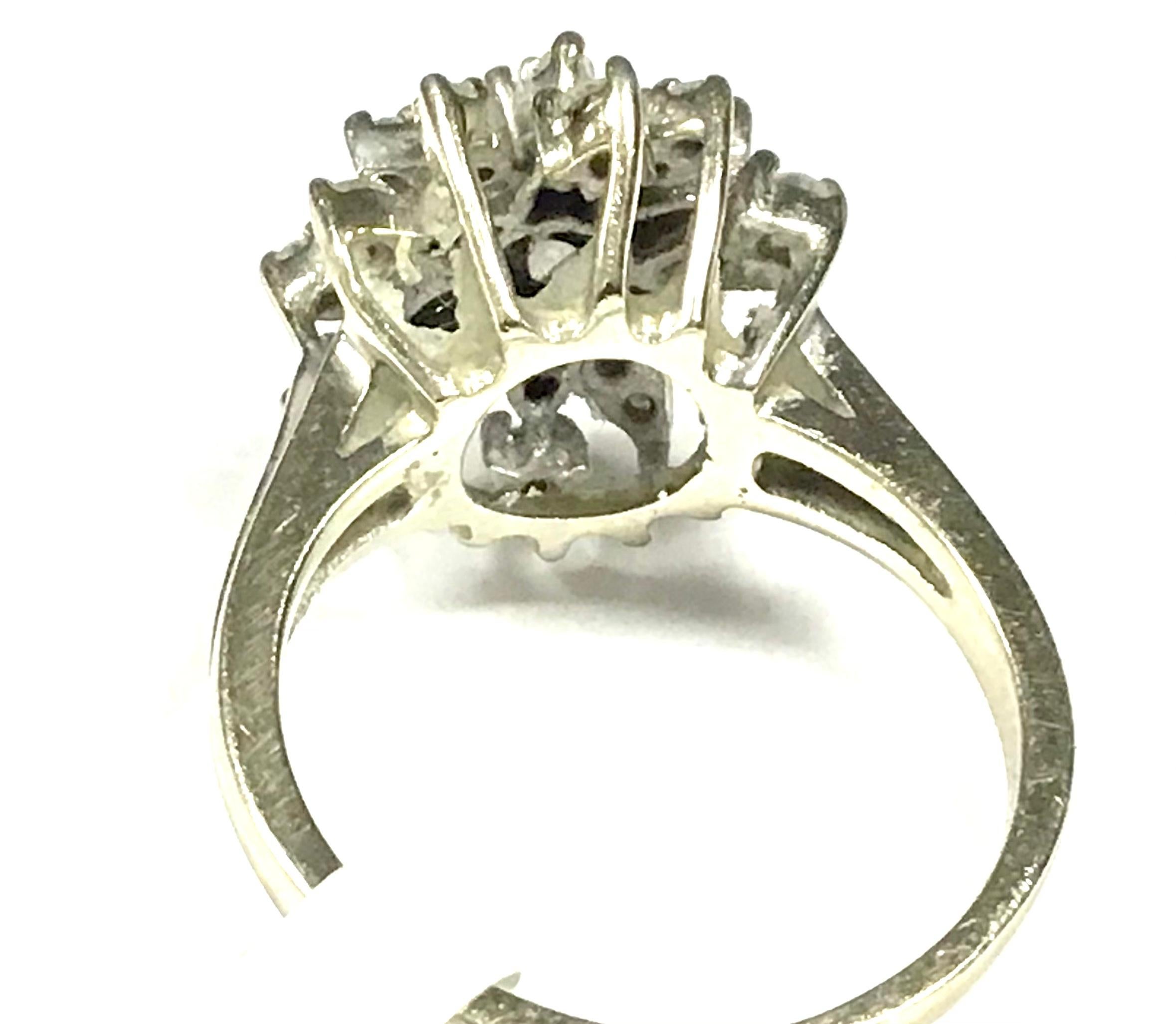 14-Karat White-Gold And Diamond Cluster Ring, 3 Gross Dwt. Diamonds weighing approximately .45 tcw. Size: 6