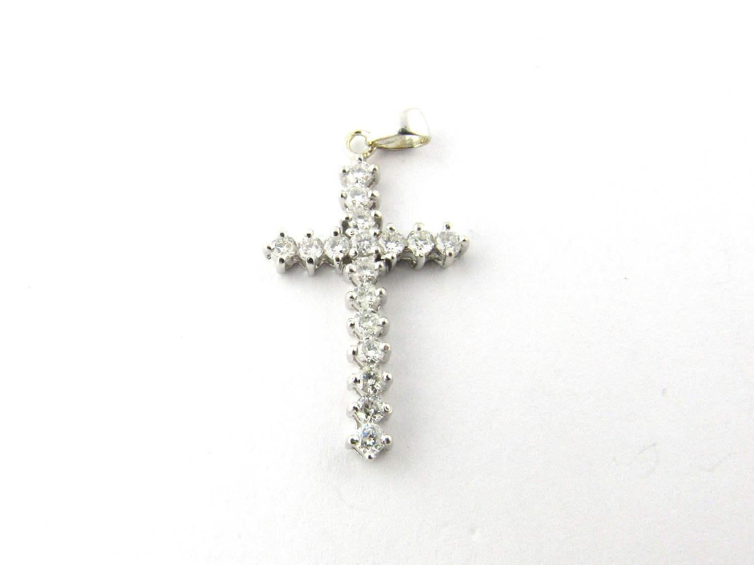 Vintage 14K White Gold and Diamond Cross Pendant. 

This lovely cross pendant is the perfect gift for the faithful and devoted. 

This pendant is approx 14 mm x 1 mm x 25 mm. 

This pendant hangs approx 28 mm from top of loop. 

1.4 g / .9 dwt. 

17