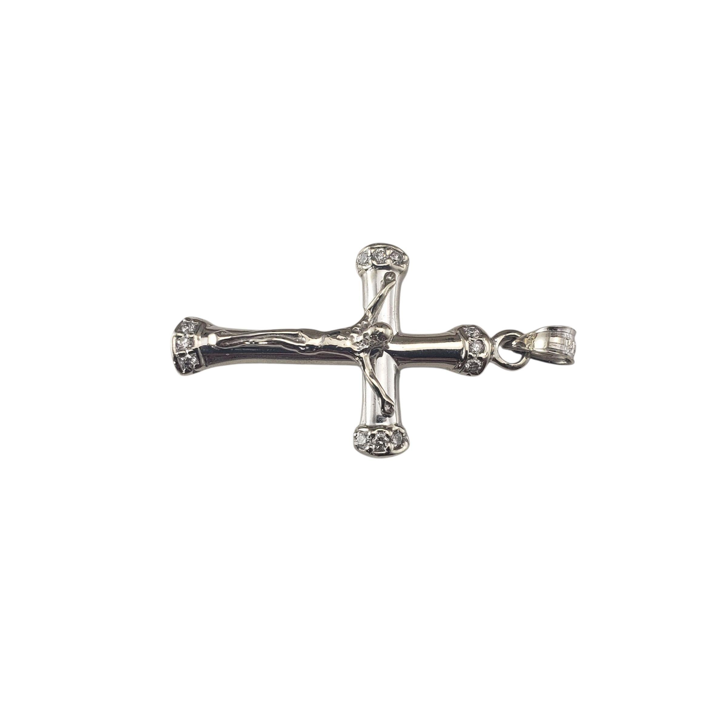 14 Karat White Gold and Diamond Crucifix Pendant-

This striking 14K white gold crucifix pedant features a detailed depiction of Christ on the cross, accented by three sparkling diamonds set at each tip, adding a touch of sparkle. This lovely piece
