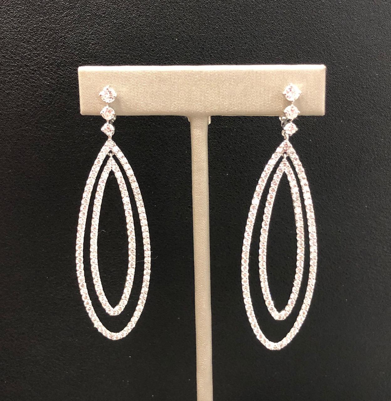The earrings are bead set with 5.05 carats of full cut round diamonds, near colorless range SI Clarity. Measuring 2.75 inches long by .75 inch wide, they have a lot of presence and are versatile for wearing at a variety of events. 
