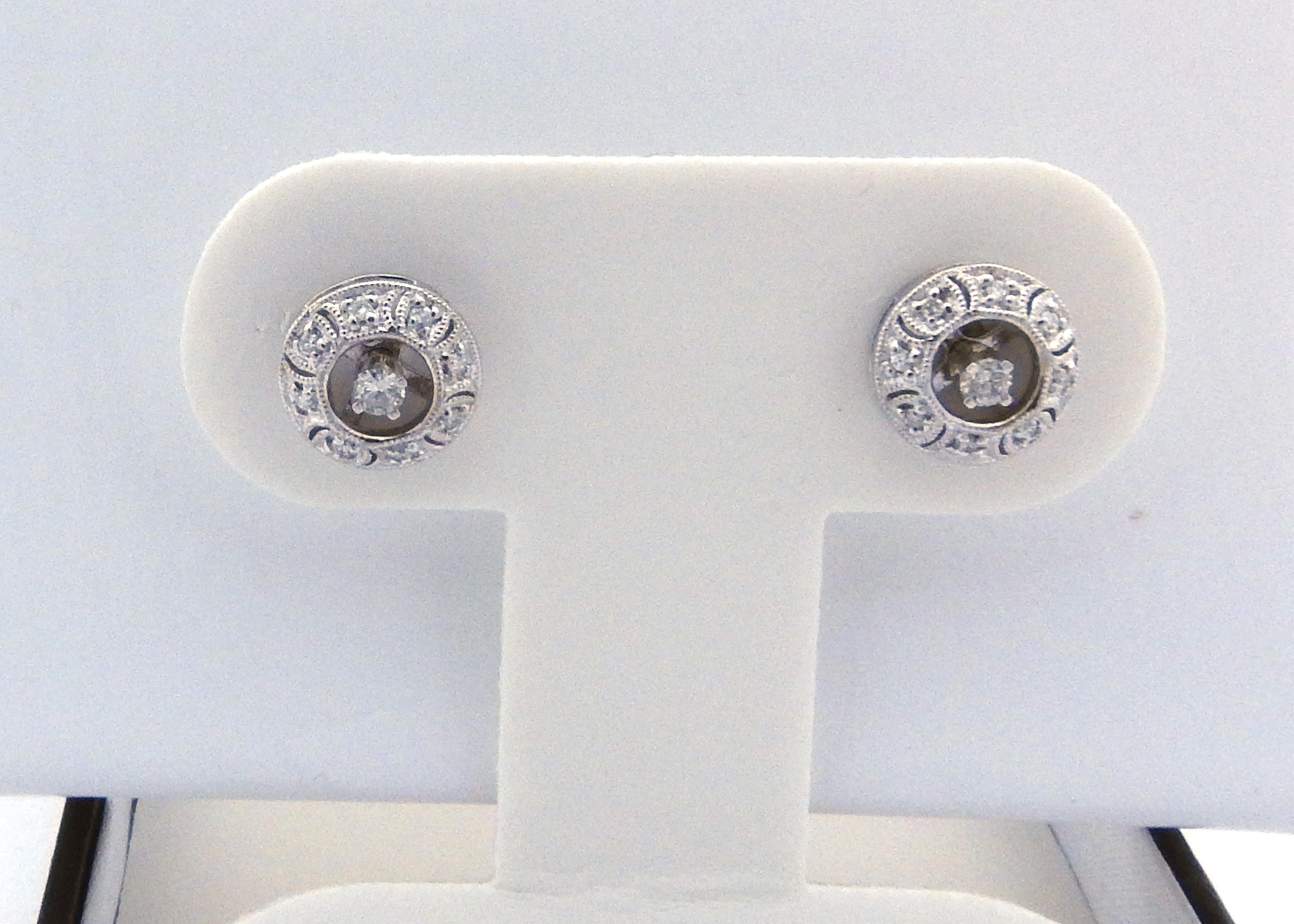 Vintage 14 Karat White Gold and Diamond Earring Jackets

These sparkling earring jackets each feature eight round brilliant cut diamonds set in beautifully detailed 14K white gold.

These jackets have an opening that will fit a think post...a screw