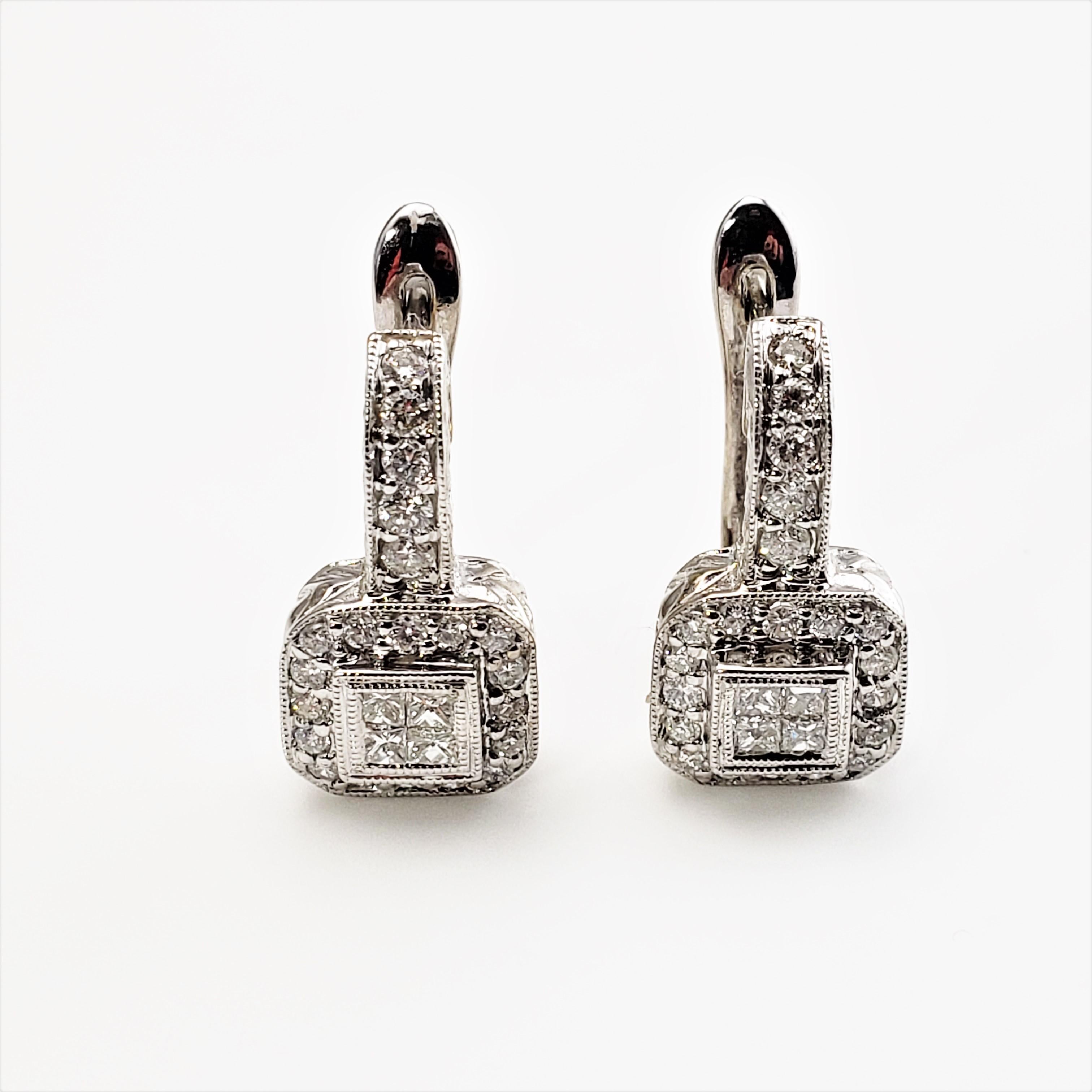 14 Karat White Gold and Diamond Earrings-

These sparkling earrings each feature four princess cut diamonds and 21 round brilliant cut diamonds set in beautifully detailed 14K white gold.  Hinged closures.

Approximate total diamond weight:  .70