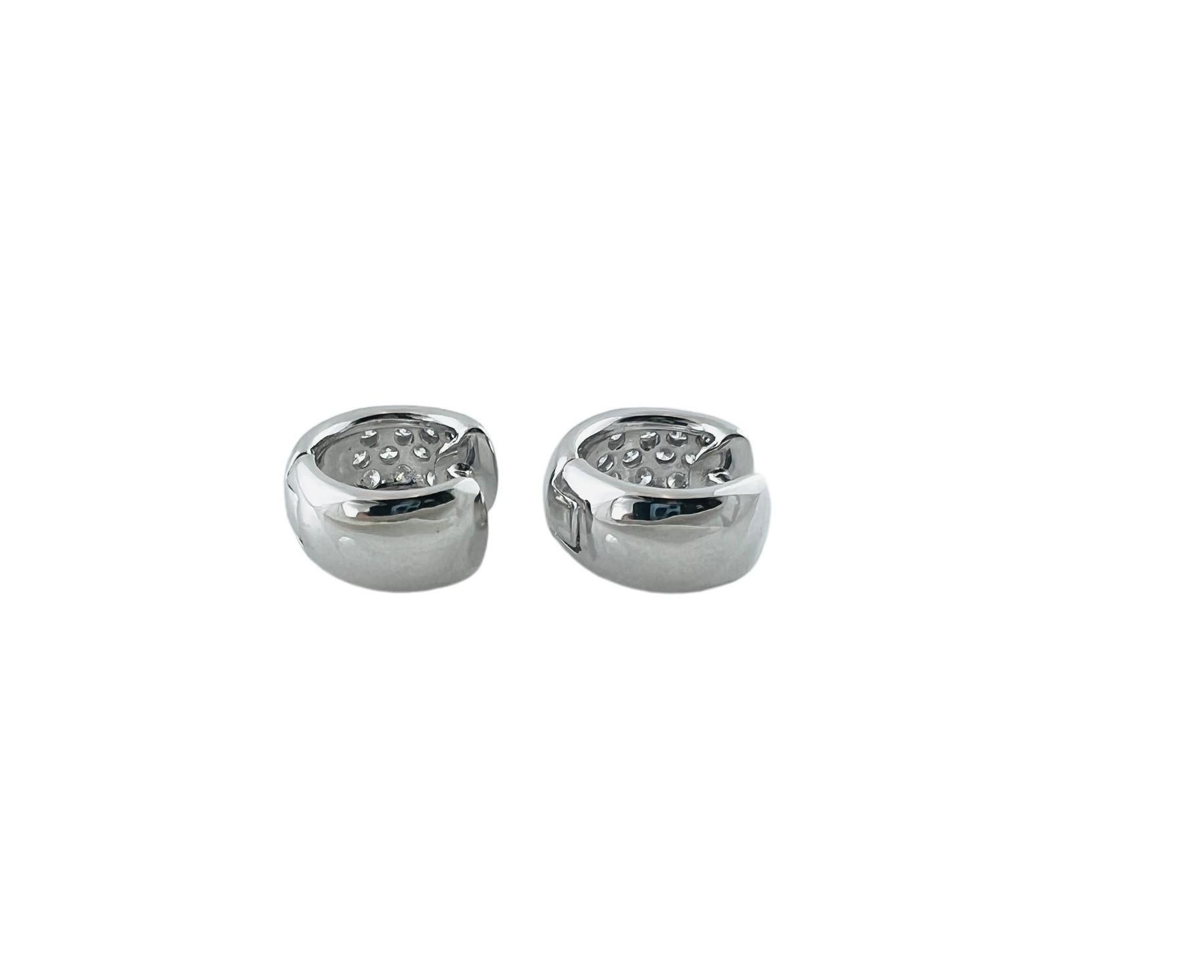 These sparkling hinged huggie earrings each feature 13 round brilliant cut diamonds set in classic 14K white gold. 

Width: 7 mm

Approximate total diamond weight: .78 ct.

Diamond color:  H

Diamond clarity: SI1-VS2

Size: 16 mm

Stamped: 