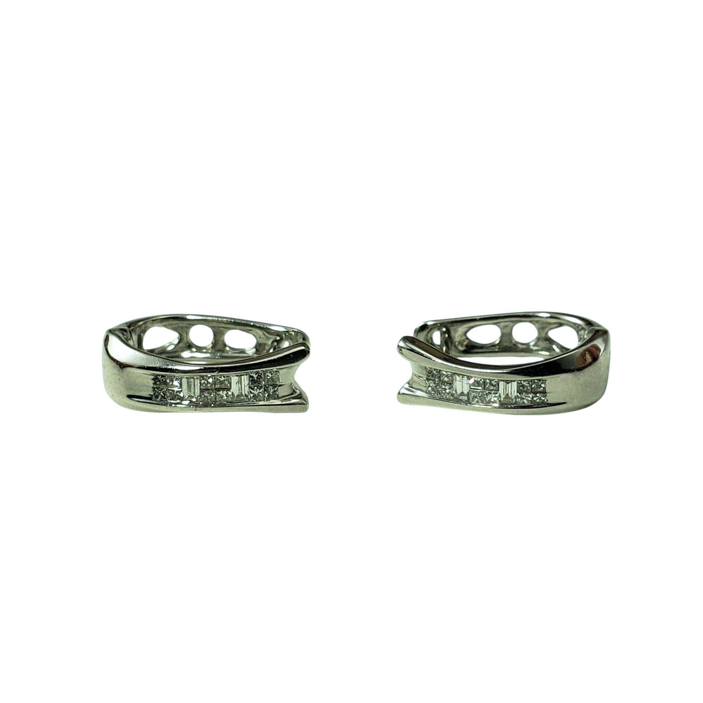 14 Karat White Gold and Diamond Huggie Earrings-

Sleek and sophisticated, these sparkling huggie hoop earrings each feature 12 princess cut diamonds and four baguette cut diamonds channel set in 14K white gold. Hinged closure.

Approximate total
