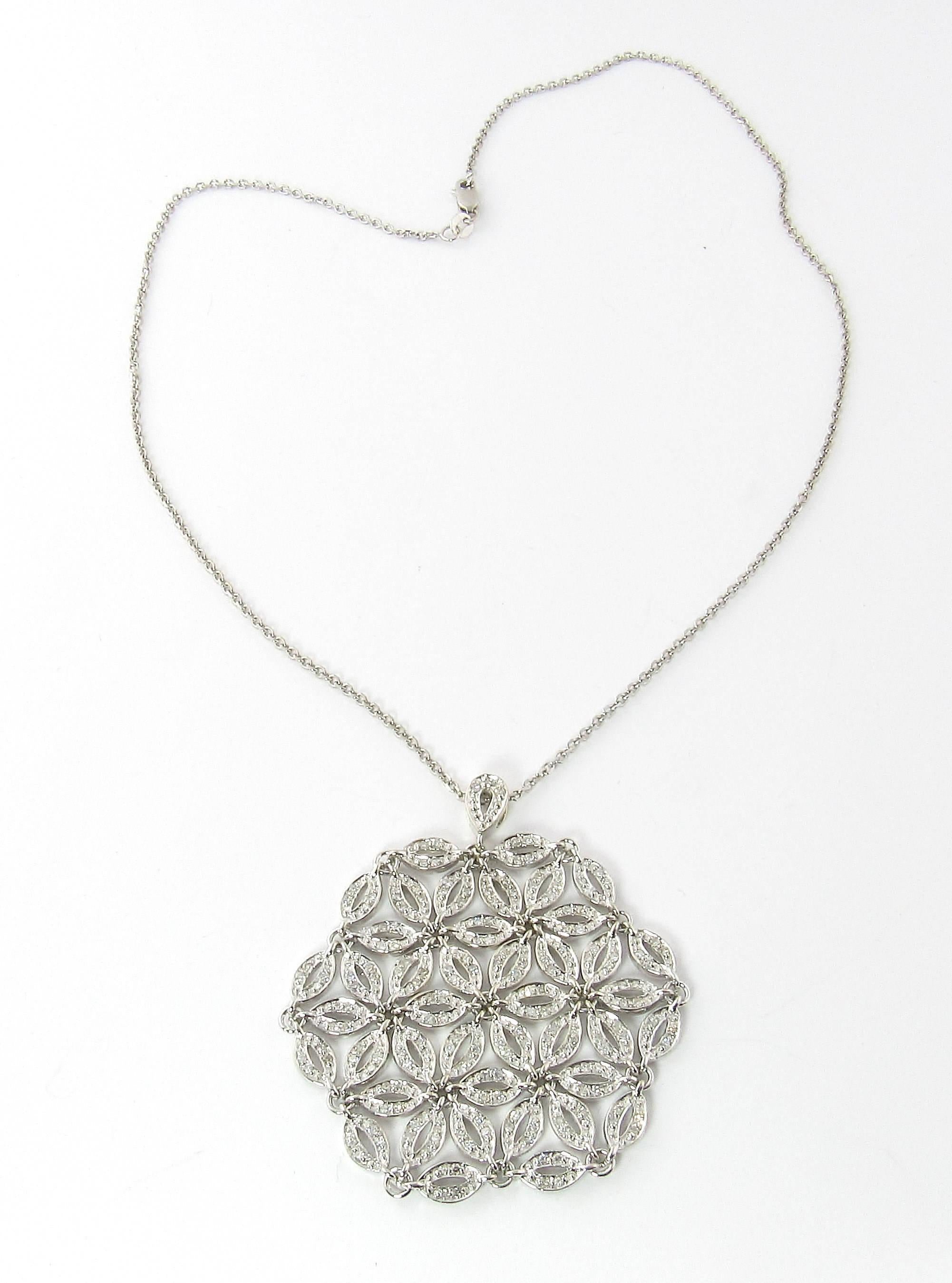 Vintage 14K White Gold and Diamond Large Floral Flexible Pendant Necklace

This unique necklace is in the shape of a snowflake with a floral pattern throughout.

The diamond ovals are all chain linked giving a flexible mesh feel to the
