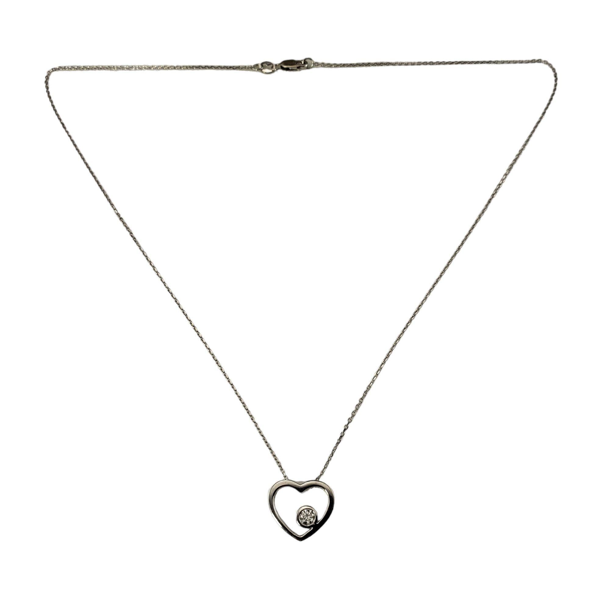 14 Karat White Gold and Diamond Open Heart Pendant Necklace-

This lovely heart pendant necklace features one round brilliant cut diamond set in classic 14K white gold. 

Approximate diamond weight: .15 ct.

Diamond clarity: VS1

Diamond color: