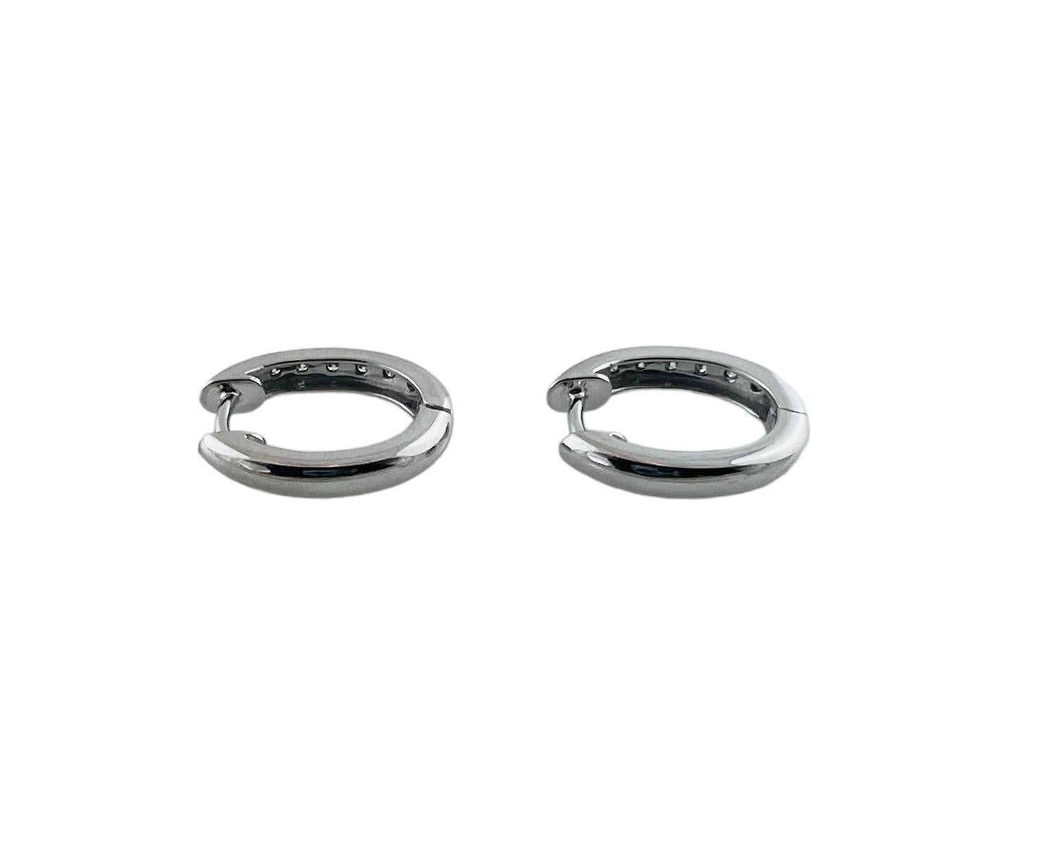These sparkling hinged hoop earrings each feature eight round brilliant cut diamonds set in classic 14K white gold.

Width: 3 mm.

Approximate total diamond weight: .16 ct.

Diamond color: G-H

Diamond clarity: SI1-I1

Size: 15 mm

Weight: 2.3 gr./