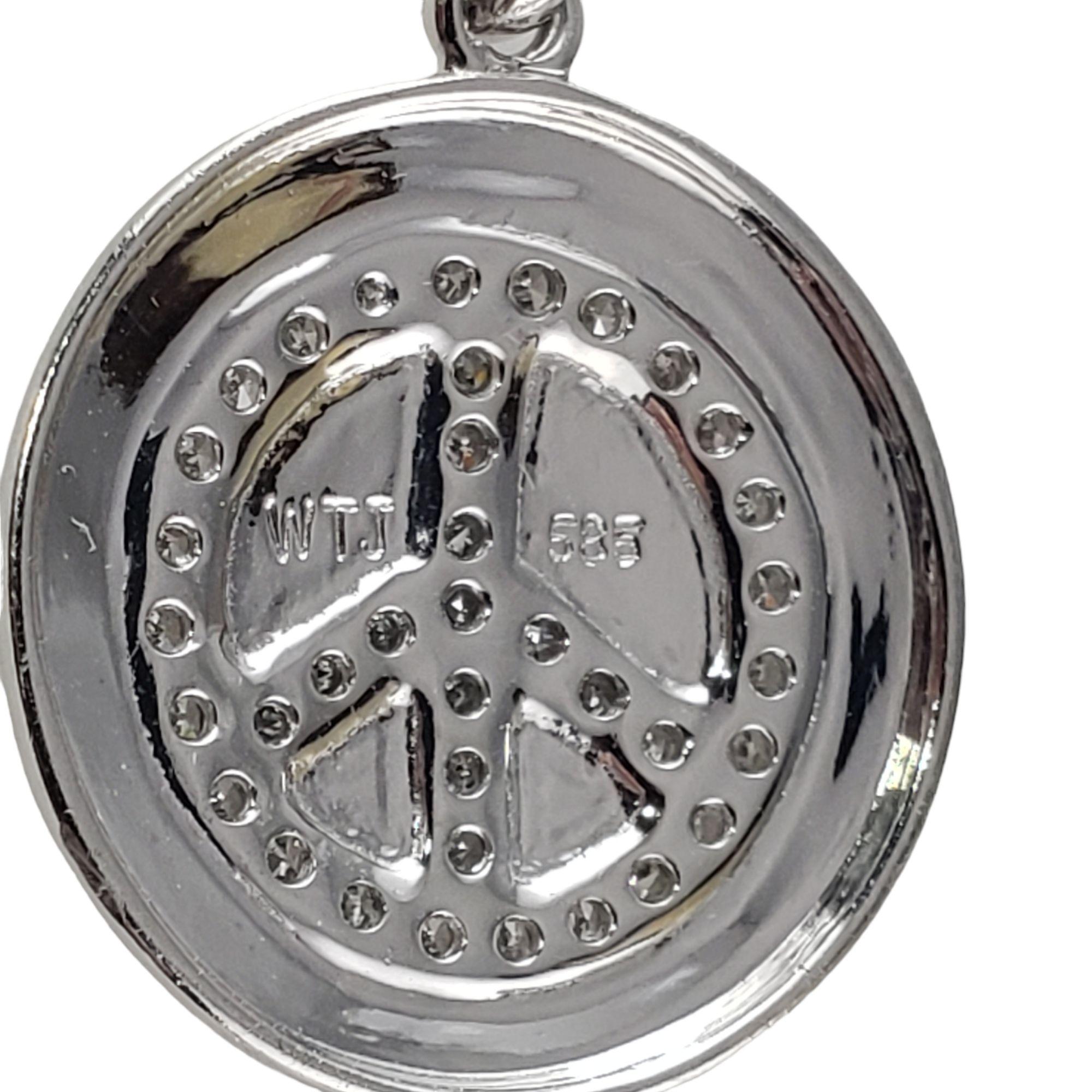 Vintage 14 Karat White Gold and Diamond Peace Pendant-

This lovely peace pendant features 37 round single cut diamonds set in beautifully detailed 14K white gold.

Approximate total diamond weight: .30 ct.

Diamond clarity: SI1

Diamond color: