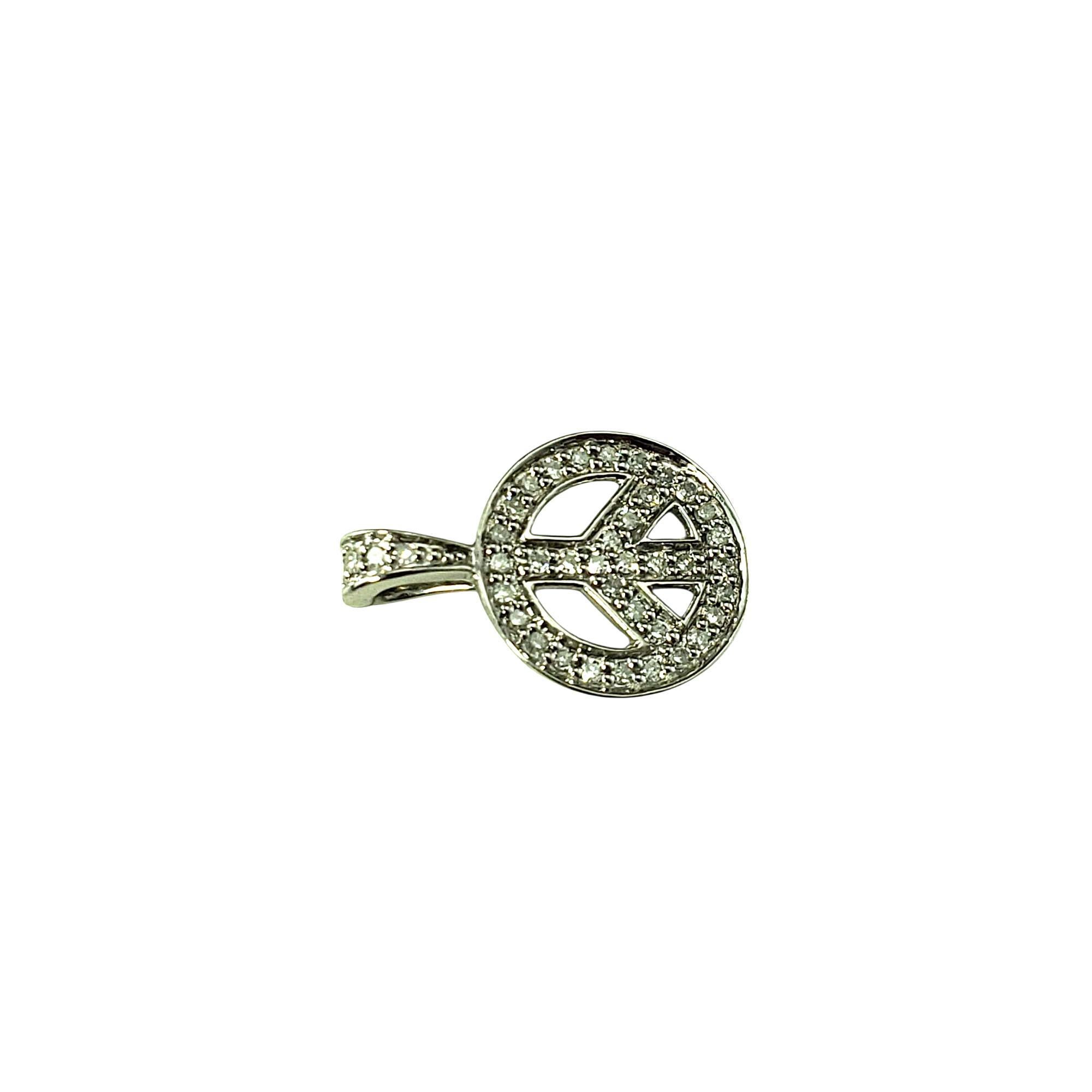 14 Karat White Gold and Diamond Peace Sign Pendant

Make a bold yet meaningful statement with this sparkling peace sign pendant, beautifully crafted and set with 29 round single cut diamonds. This iconic symbol of harmony and love is brought to life