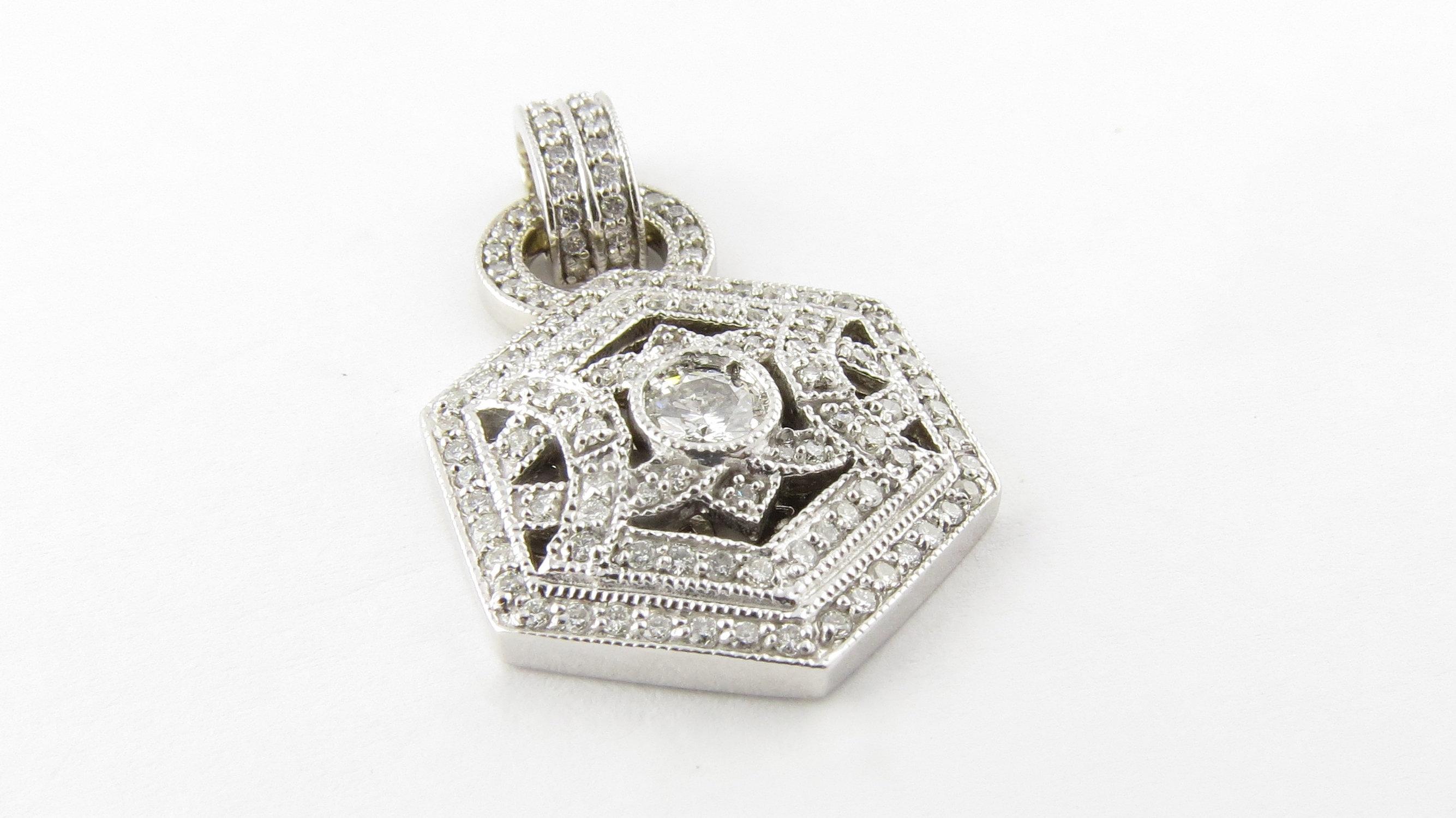 Vintage 14 Karat White Gold and Diamond Pendant- 
This fabulous pendant features 123 brilliant cut diamonds set in stunning 14K white gold. Center: .35 ct. 
Approximate total diamond weight: 1.58 ct. 
Diamond color: H 
Diamond clarity: SI1-I1 
Size: