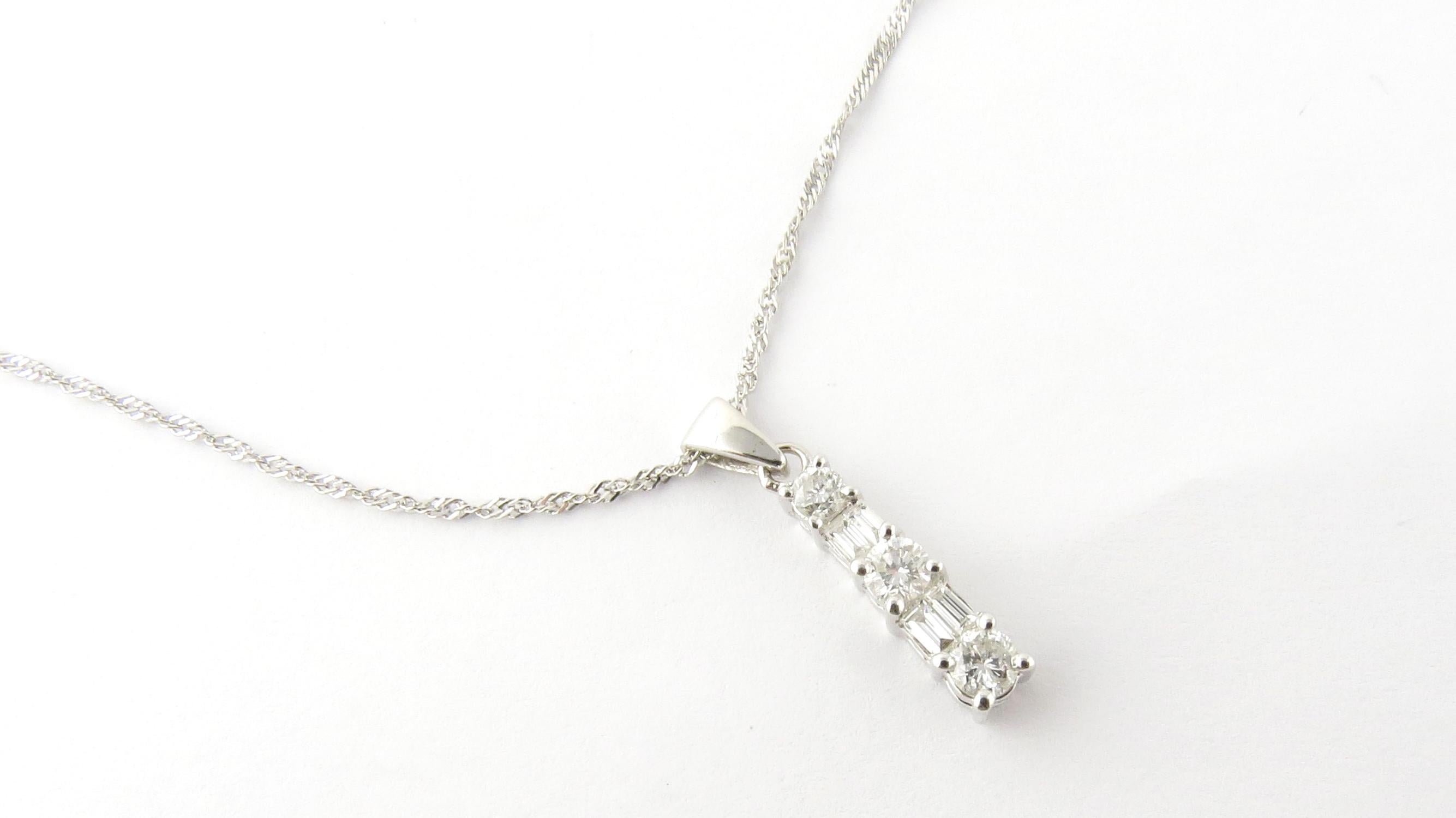Vintage 14 Karat White Gold and Diamond Pendant Necklace

This sparkling pendant features three round brilliant cut diamonds (.30 ct. twt.) and four baguette diamonds (.14 ct. twt.) set in classic 14K white gold. Suspended from a lovely 14K