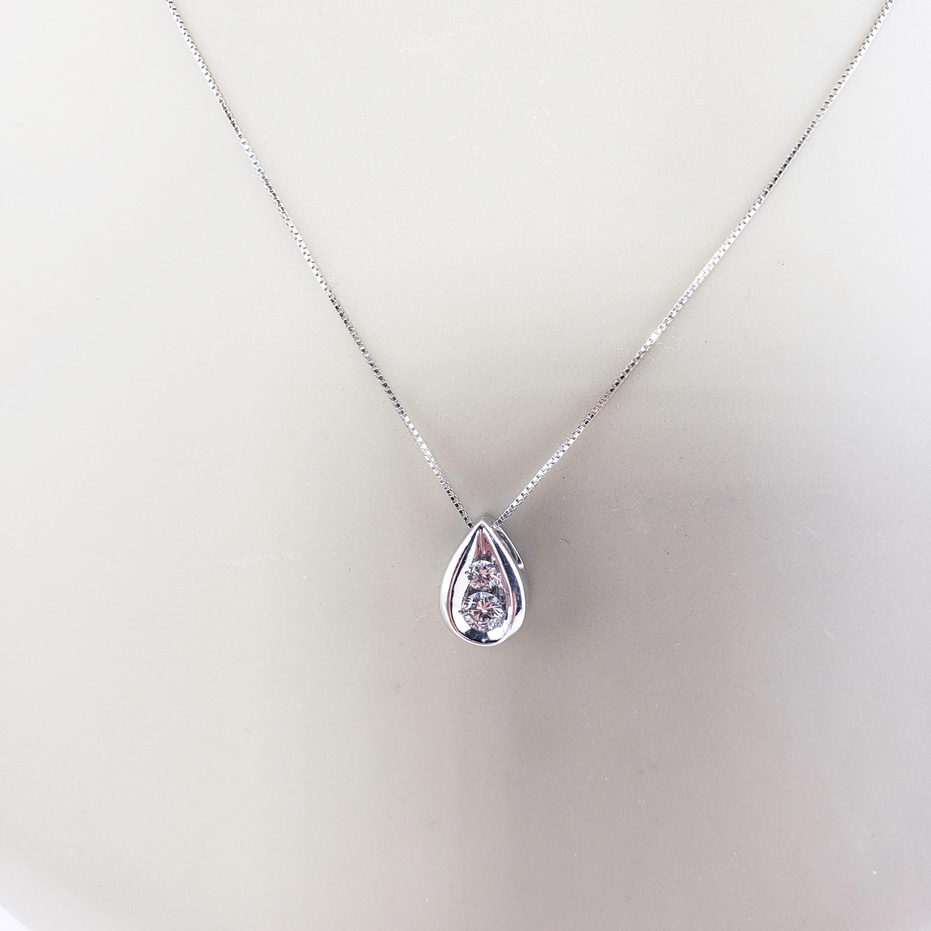 Vintage 14 Karat White Gold Diamond Pendant Necklace-

This sparkling tear drop pendant features two round brilliant cut diamonds set in elegant 14K white gold. Suspends from a classic box chain necklace.

Approximate total diamond weight: .22