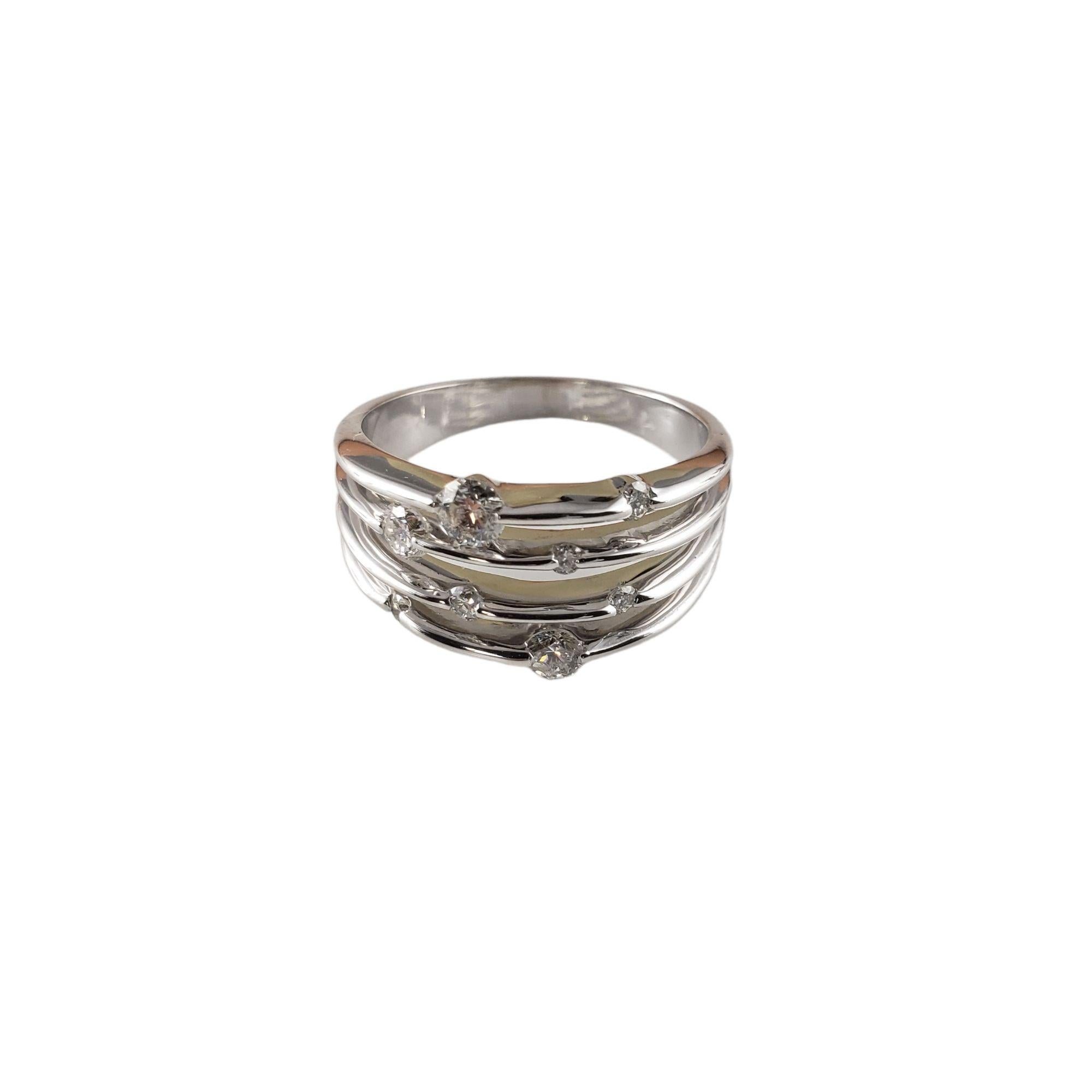 Vintage 14 Karat White Gold and Diamond Band Ring Size 10-

This lovely fixed four band ring features eight round brilliant cut diamonds set in classic 14K white gold.  Width:  12 mm.  Shank: 3 mm.

Approximate total diamond weight:   .50