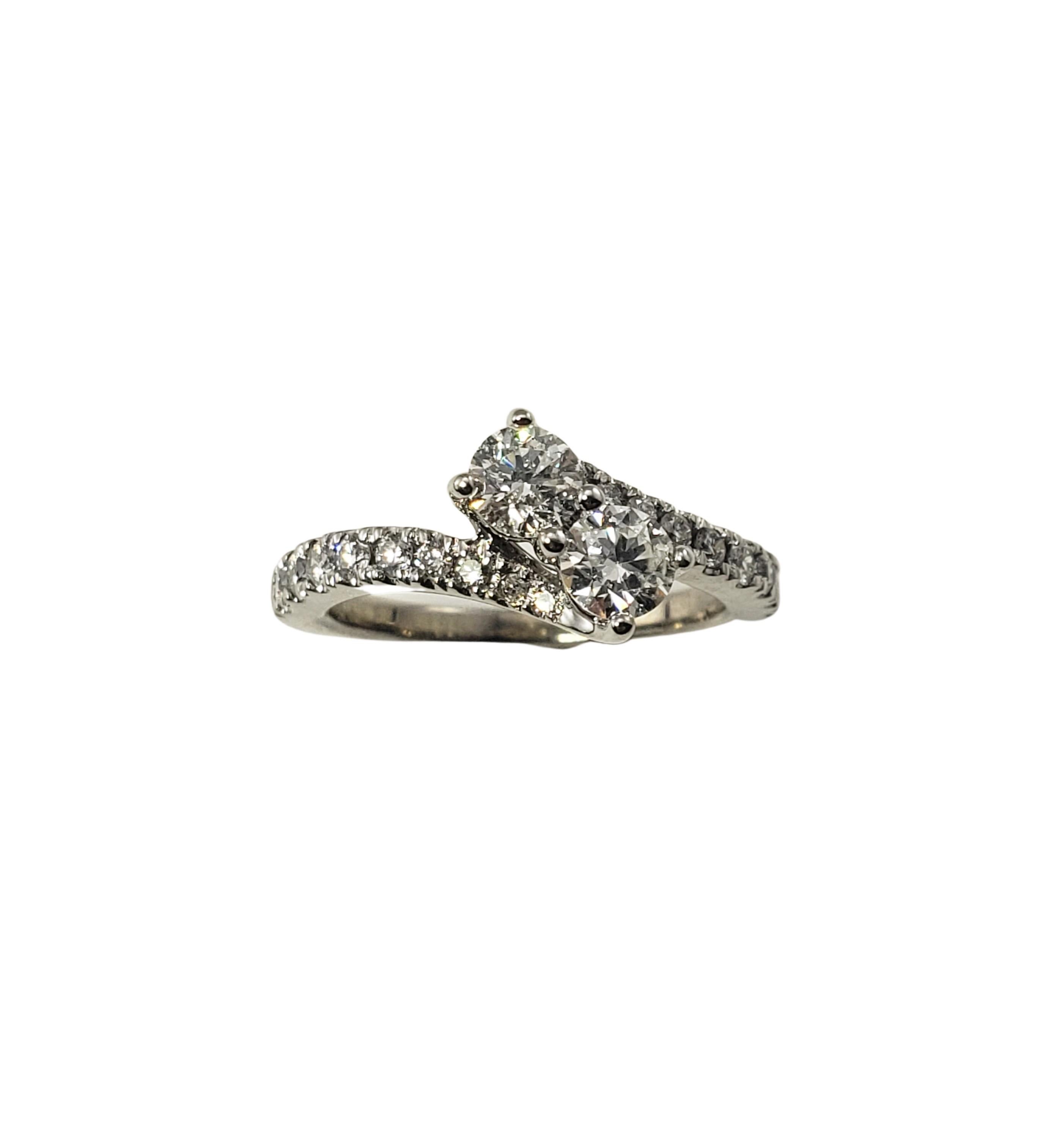 14 Karat White Gold and Diamond Ring Size 6.25-

This sparkling 14K white gold ring features two round brilliant cut diamonds in its center (total weight: .60 ct.) and 18 round brilliant cut diamonds on its band (total weight: .30 ct.).